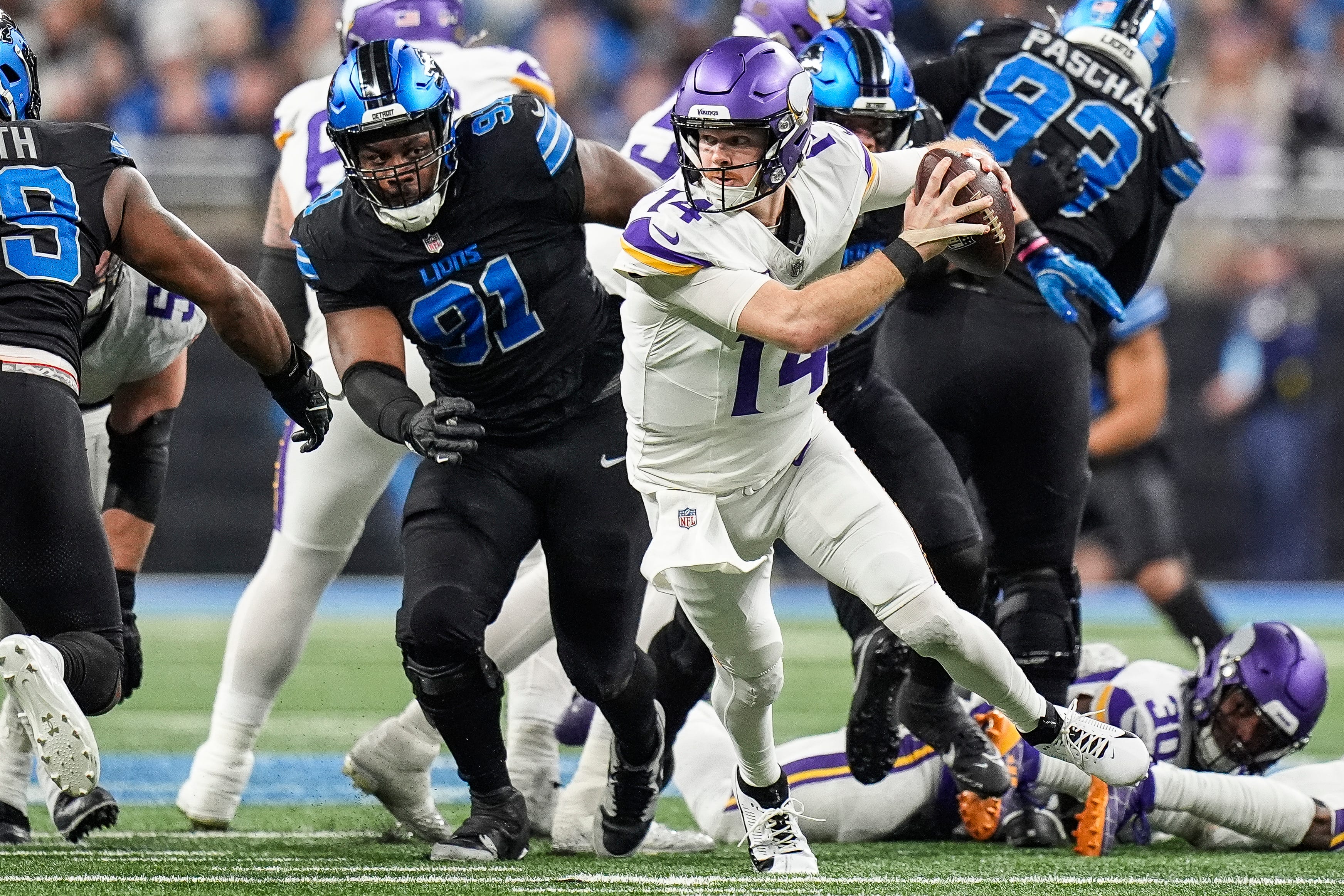 Minnesota Vikings linebacker Pat Jones II (91) pressures Minnesota Vikings quarterback Sam Darnold (14) during the first half at Ford Field in Detroit on Sunday, Jan. 5, 2025.
