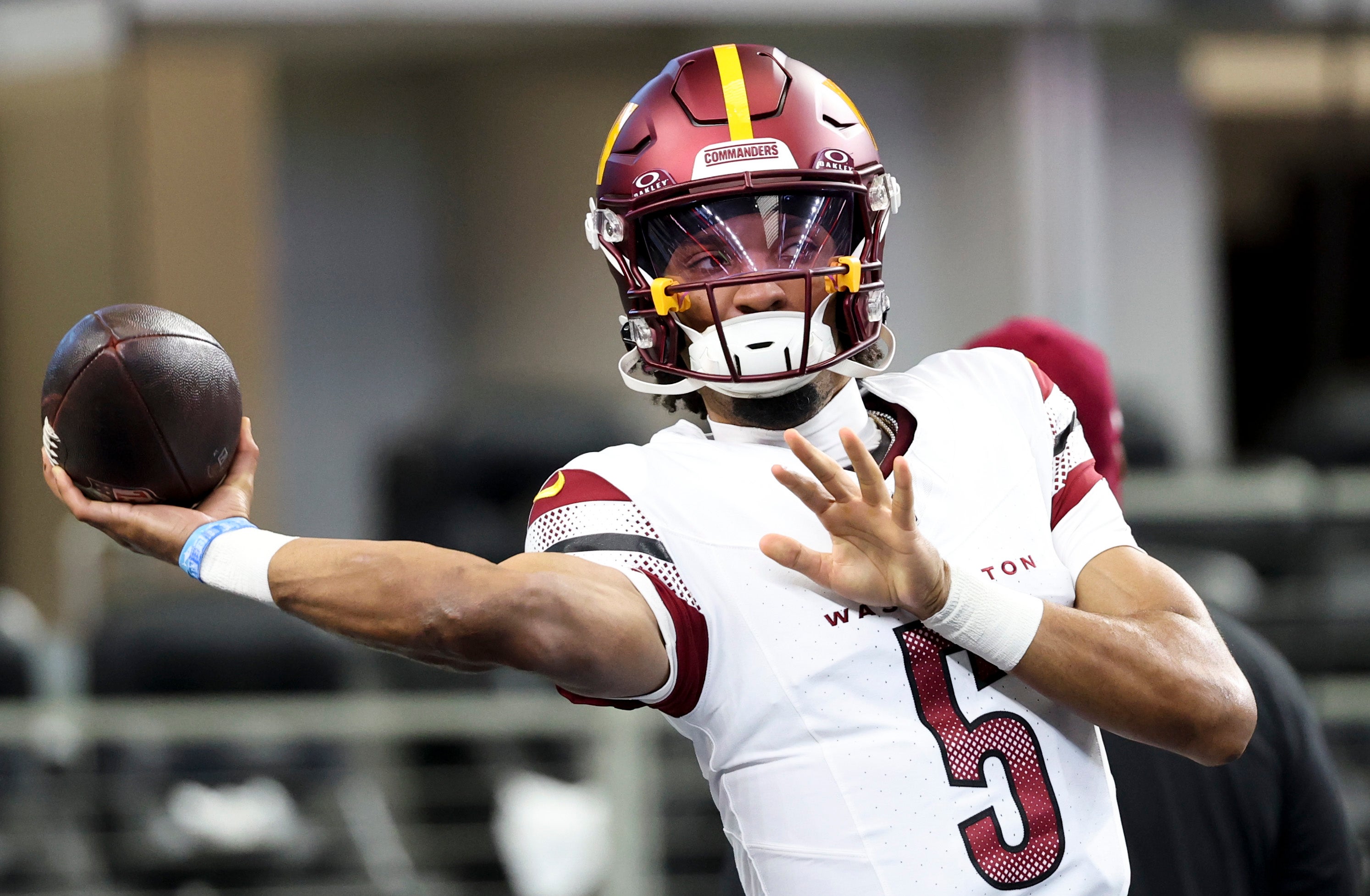 Jan 5, 2025; Arlington, Texas, USA; Washington Commanders quarterback Jayden Daniels (5) warms up before the game against the Dallas Cowboys at AT&T Stadium.