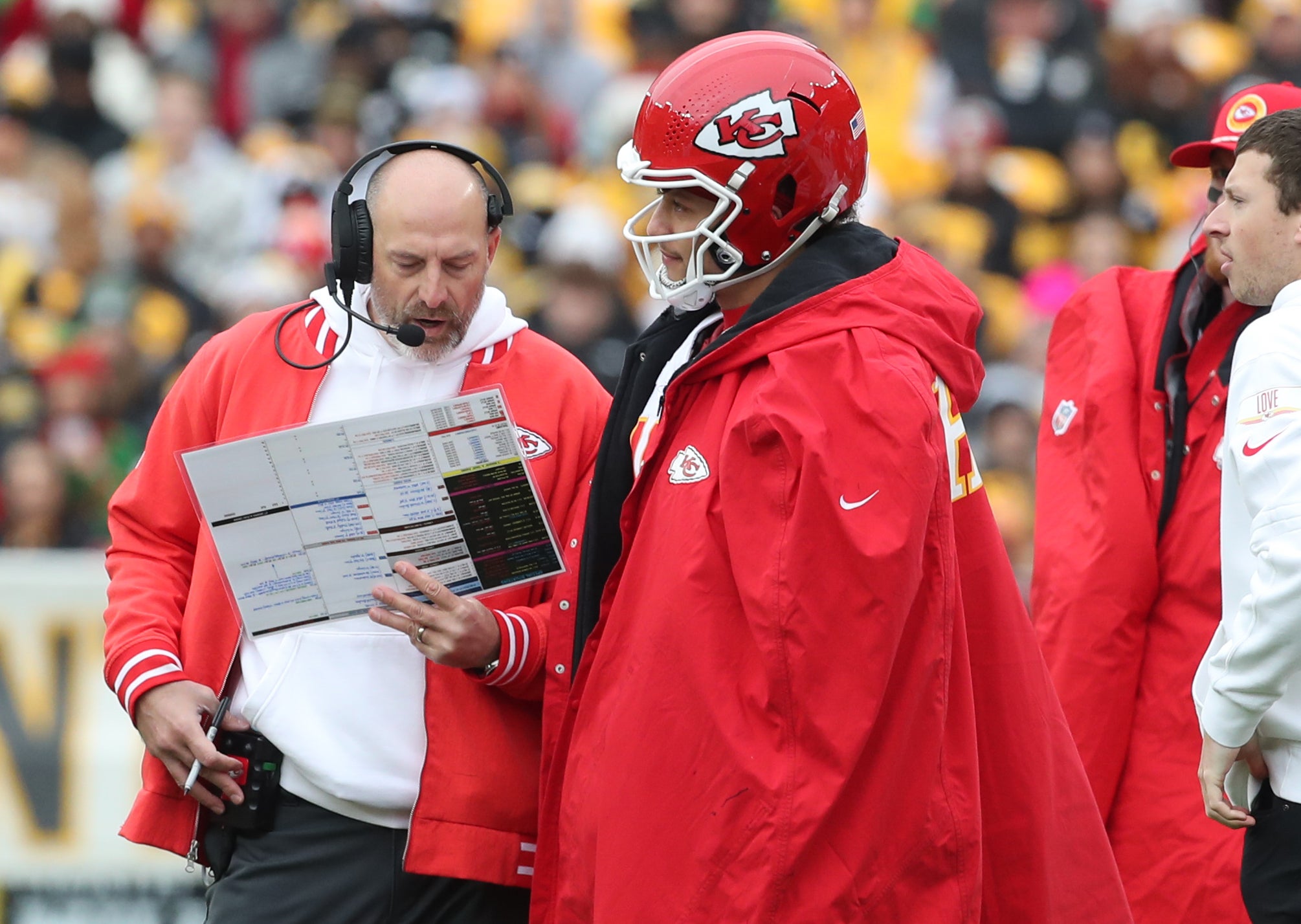 Chiefs offensive coordinator Matt Nagy (left) and quarterback Patrick Mahomes (right) look over a play chart during a time-out against the Steelers.
