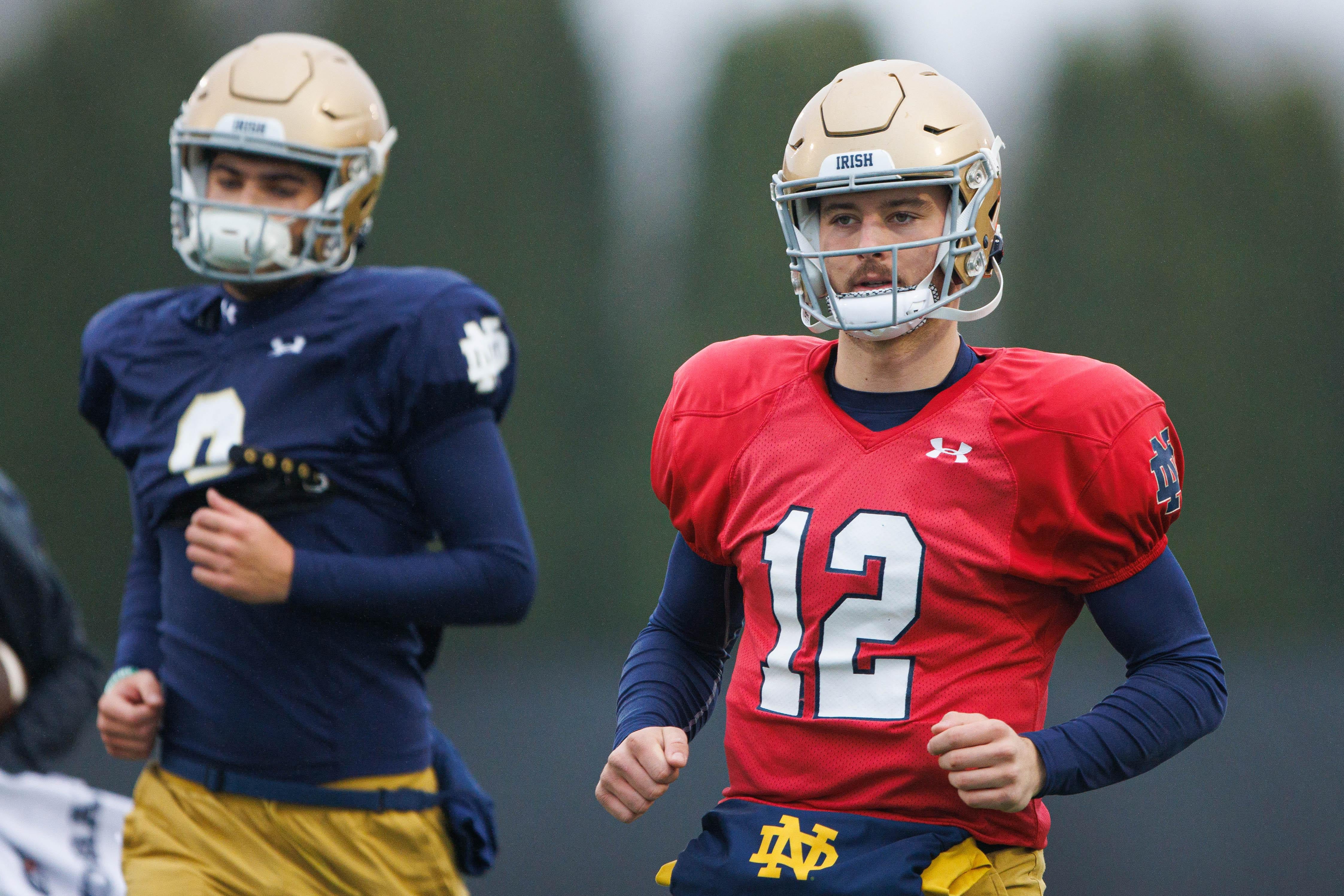 Notre Dame quarterback CJ Carr (12) runs to a drill during a Notre Dame football practice at Irish Athletic Center on Monday, Dec. 16, 2024, in South Bend.