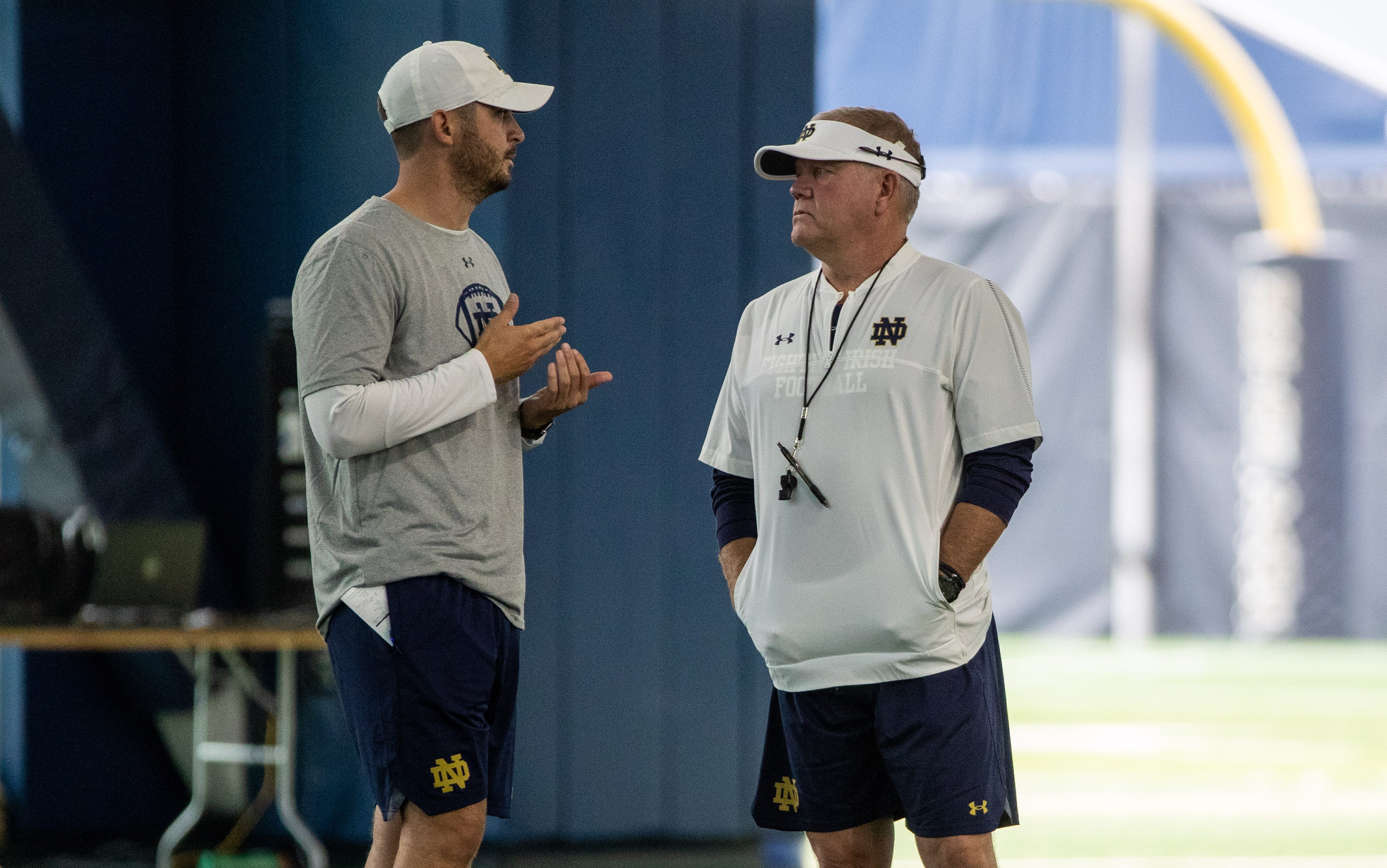 Notre Dame offensive coordinator coach Tommy Rees and head coach Brian Kelly discuss strategy during Notre Dame Fall Camp on Saturday, August 07, 2021, at Irish Athletics Center in South Bend, Indiana. Ncaa Foorball 2021 Notre Dame Fall Camp
