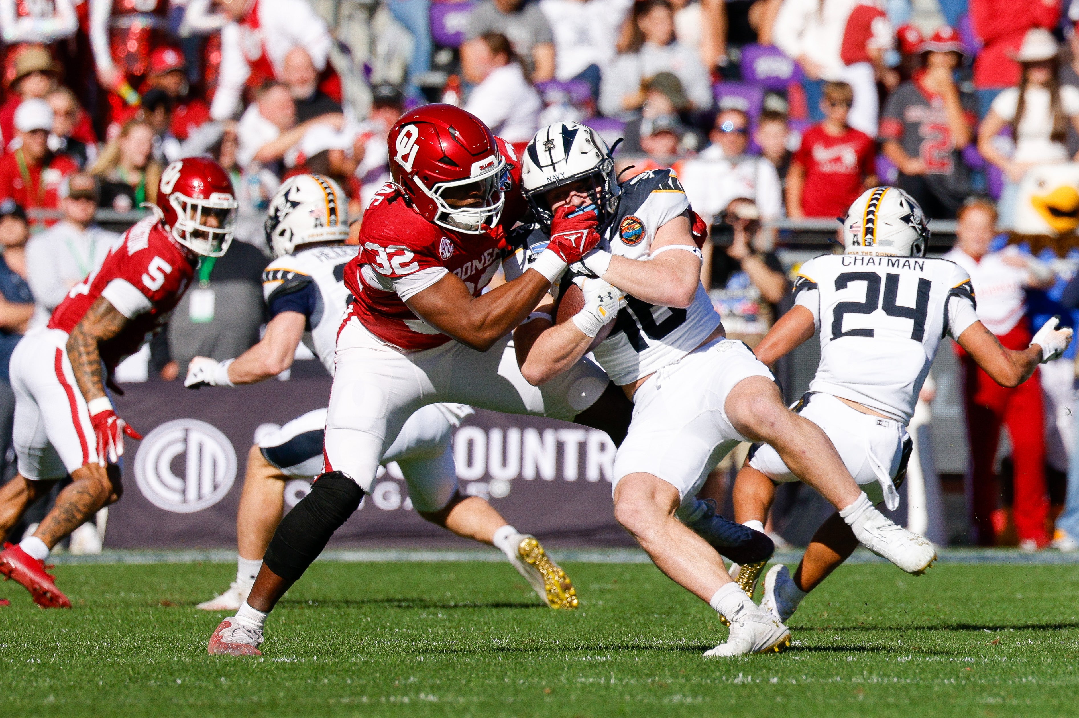 Dec 27, 2024; Fort Worth, TX, USA; Oklahoma Sooners defensive lineman R Mason Thomas (32) tackles Navy Midshipmen fullback Alex Tecza (46) during the first quarter at Amon G. Carter Stadium.