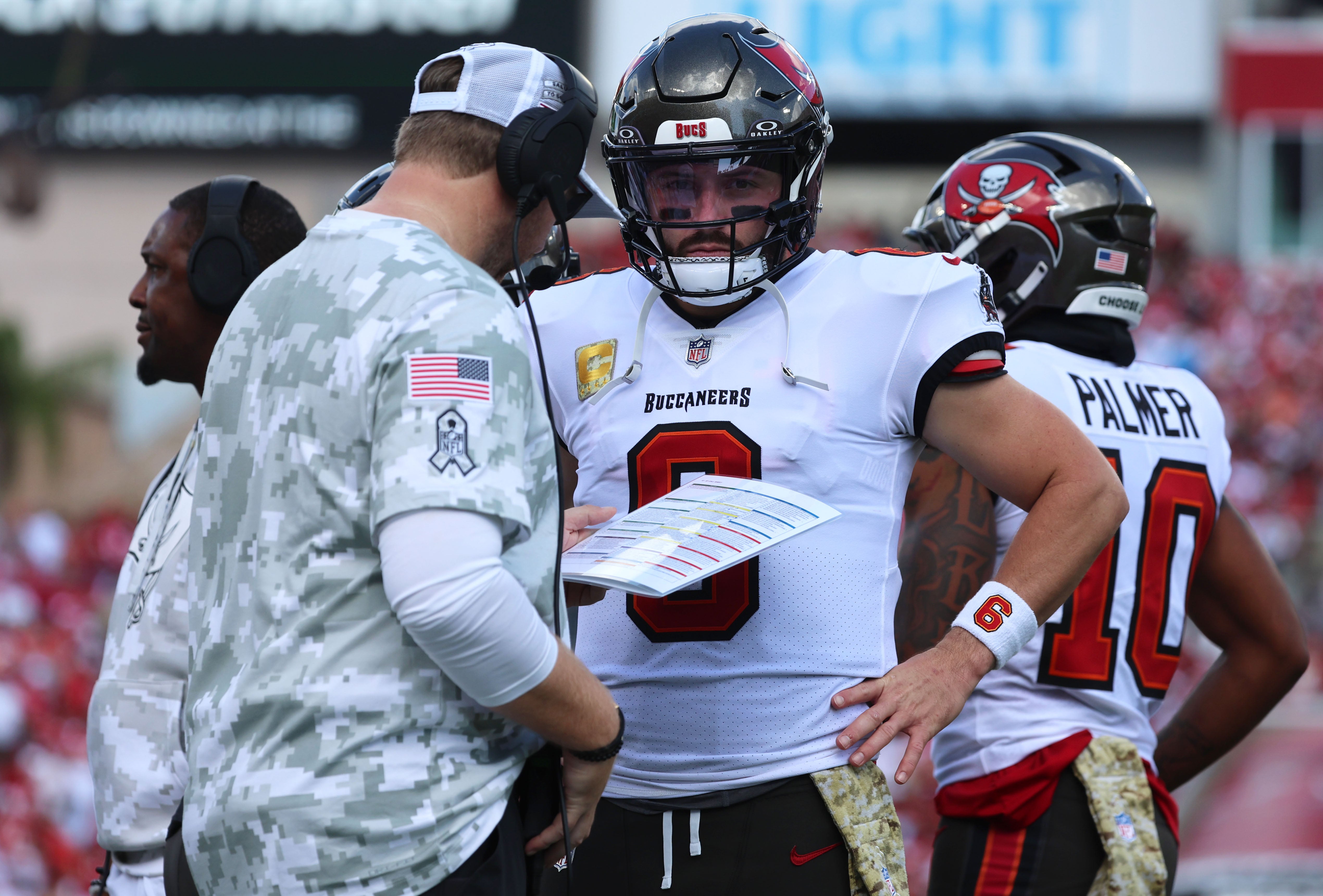 Nov 10, 2024; Tampa, Florida, USA; Tampa Bay Buccaneers quarterback Baker Mayfield (6) talks with offensive coordinator Liam Coen during the first half against the San Francisco 49ers at Raymond James Stadium.