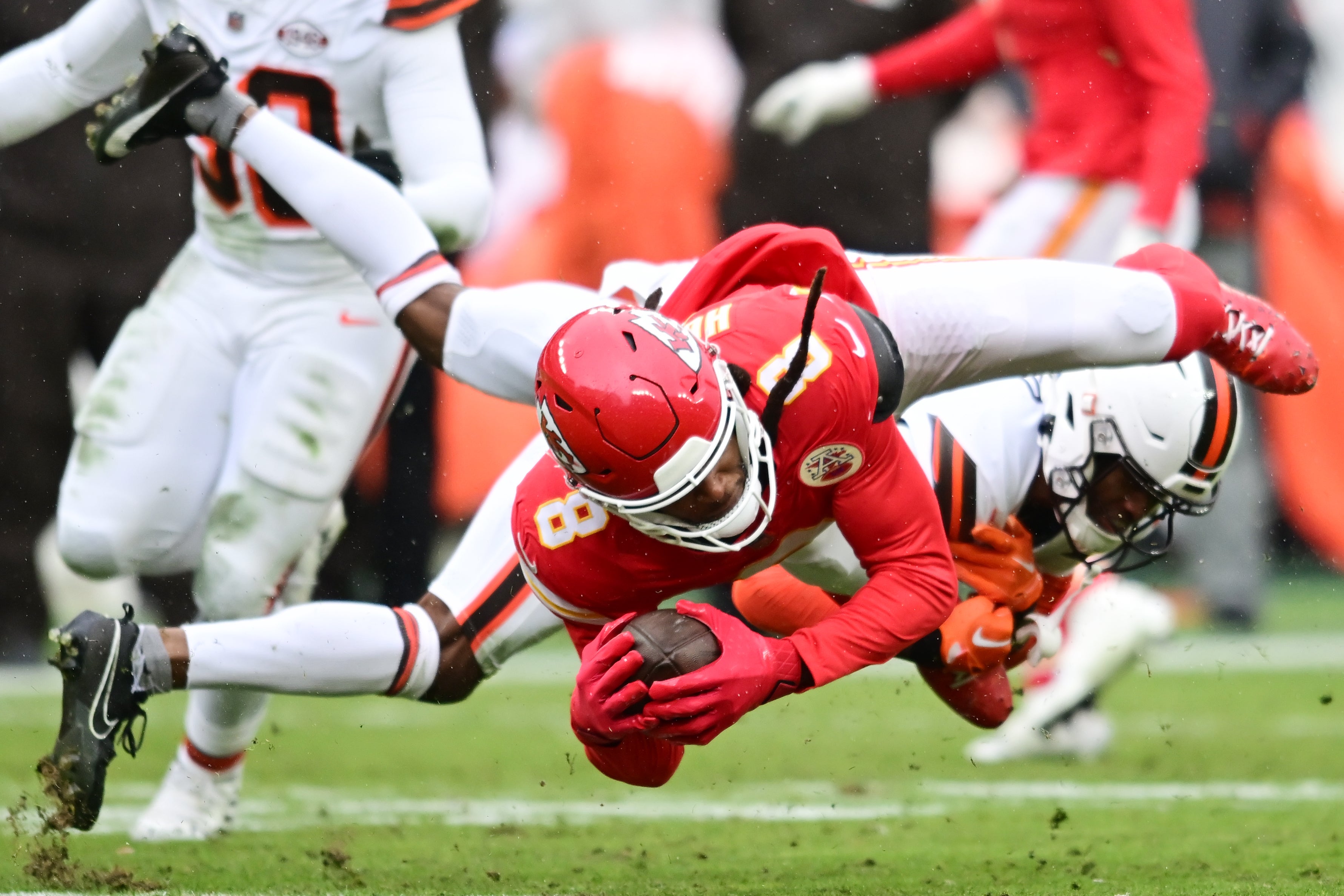 Dec 15, 2024; Cleveland, Ohio, USA; Cleveland Browns cornerback Denzel Ward (21) tackles Kansas City Chiefs wide receiver DeAndre Hopkins (8) during the first half at Huntington Bank Field.