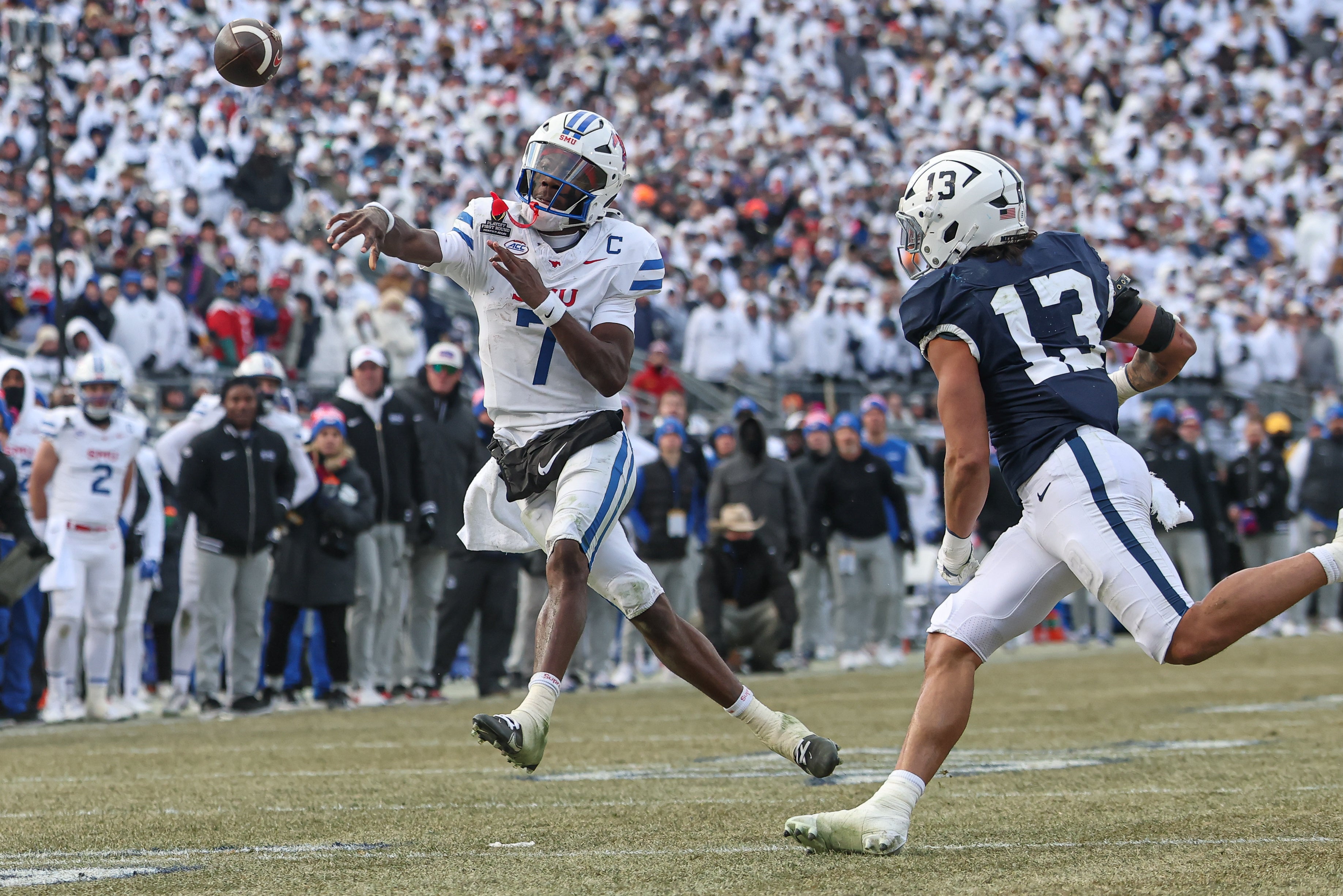 Southern Methodist Mustangs quarterback Kevin Jennings (7) throws the ball asPenn State Nittany Lions linebacker Tony Rojas (13) pursues during the second half at Beaver Stadium.