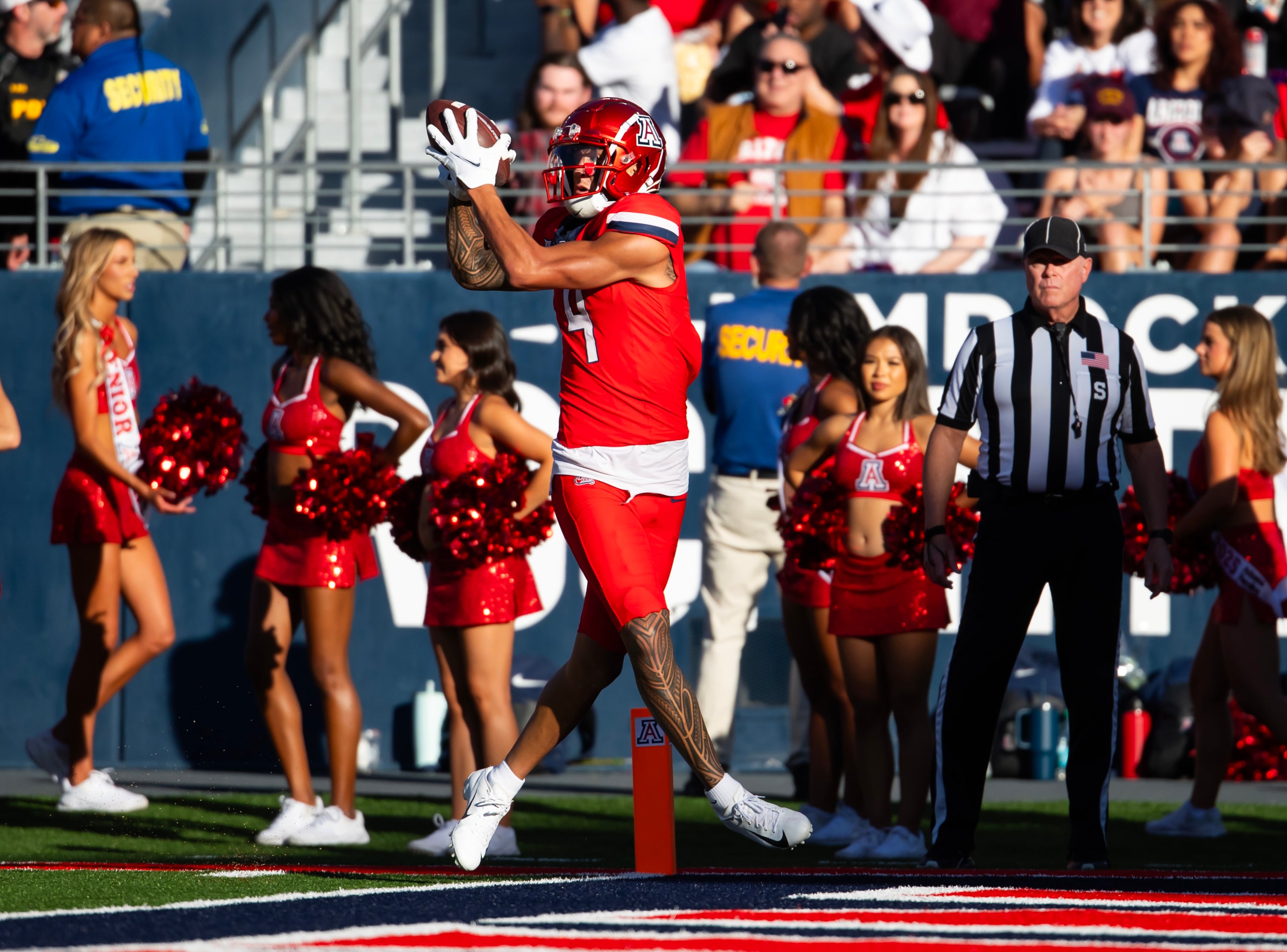 Nov 30, 2024; Tucson, Arizona, USA; Arizona Wildcats wide receiver Tetairoa McMillan (4) catches a touchdown against the Arizona State Sun Devils in the second half during the Territorial Cup at Arizona Stadium.