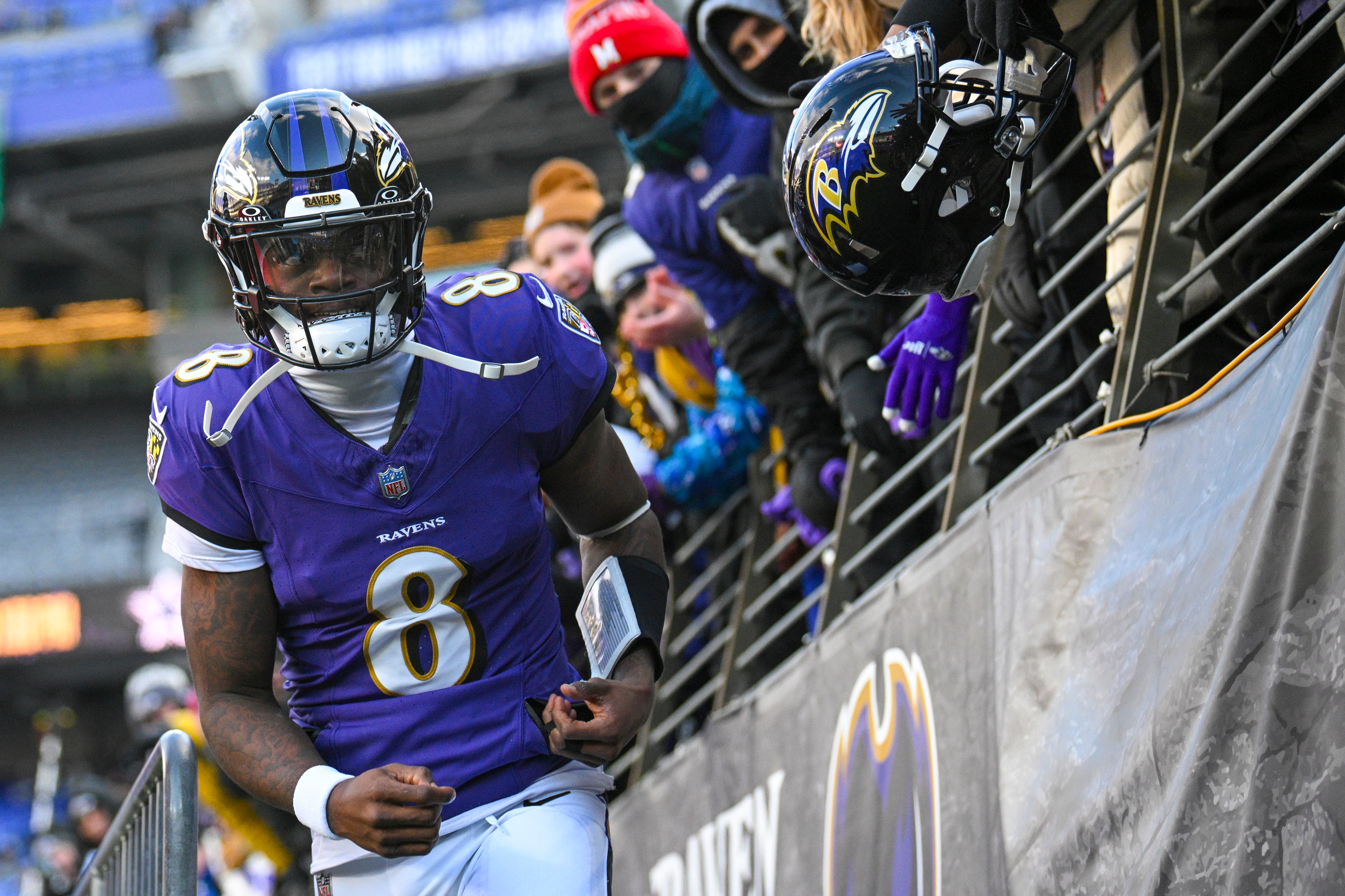 Jan 4, 2025; Baltimore, Maryland, USA; Baltimore Ravens quarterback Lamar Jackson (8) looks towards the crowds while entering the field before the game against the Cleveland Browns at M&T Bank Stadium.