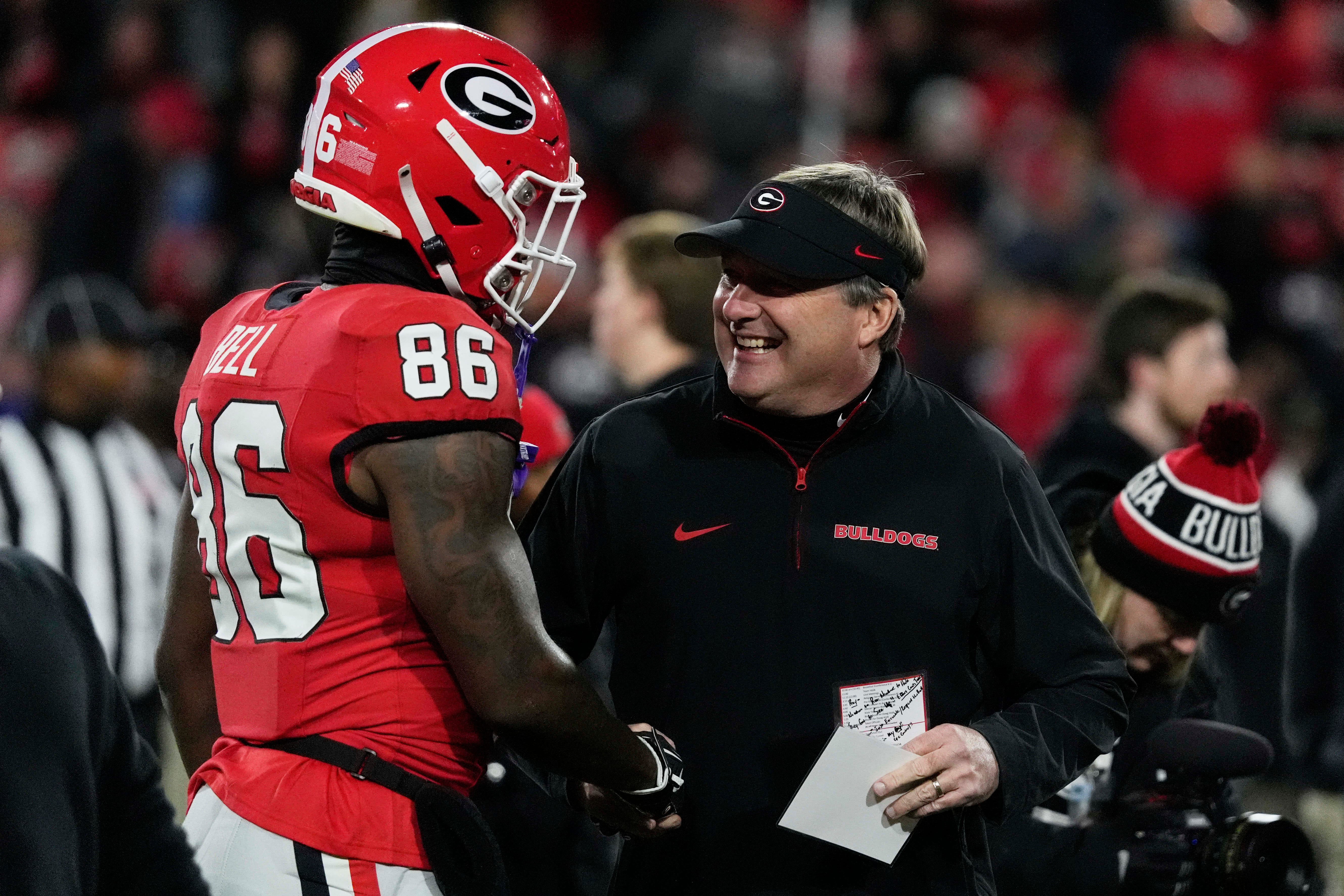 Georgia wide receiver Dillon Bell (86) speaks with Georgia coach Kirby Smart during warm ups before the start of a NCAA college football game against Georgia Tech in Athens, Ga.