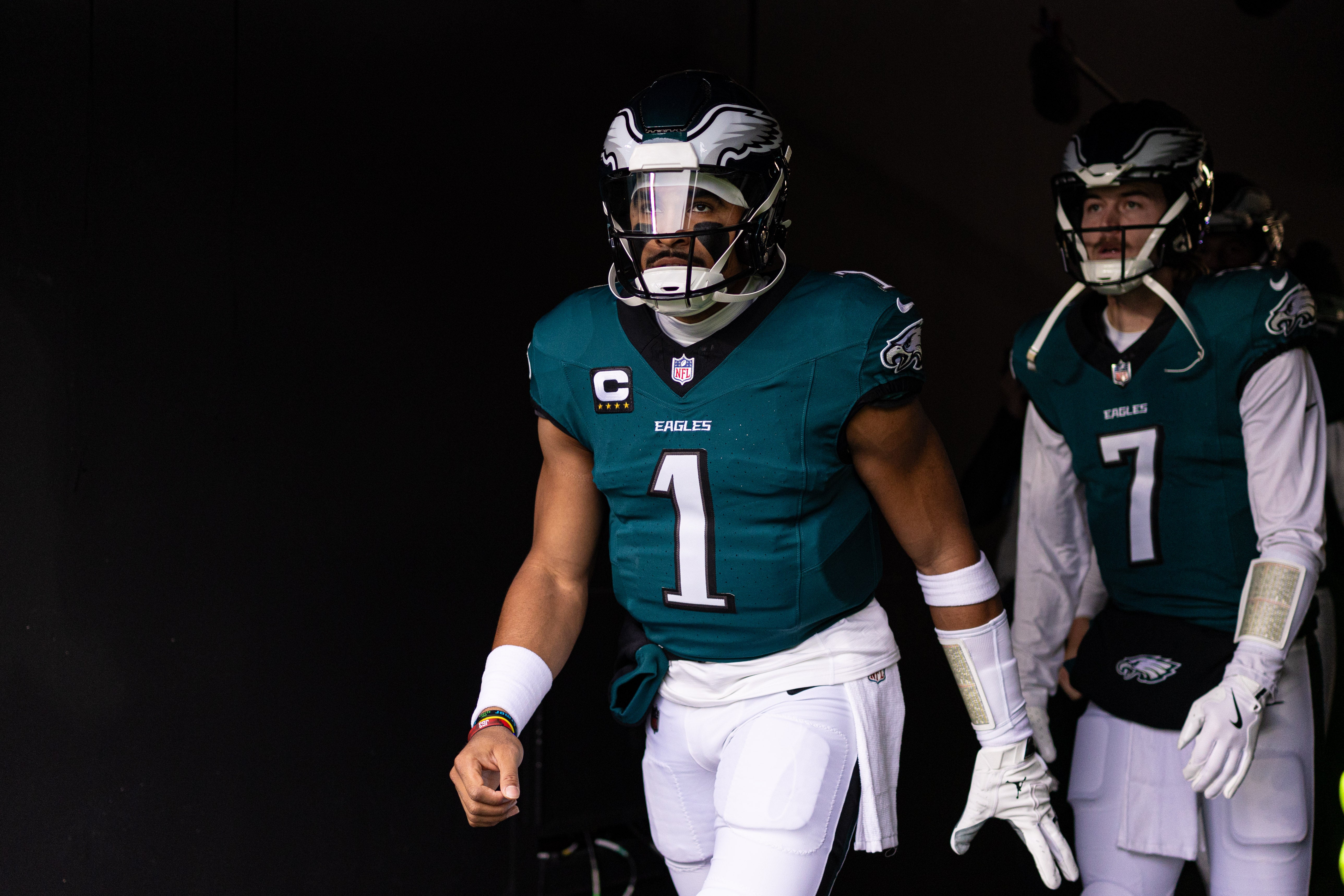 Philadelphia Eagles quarterback Jalen Hurts (1) and quarterback Kenny Pickett (7) take the field for warm ups against the Pittsburgh Steelers at Lincoln Financial Field.
