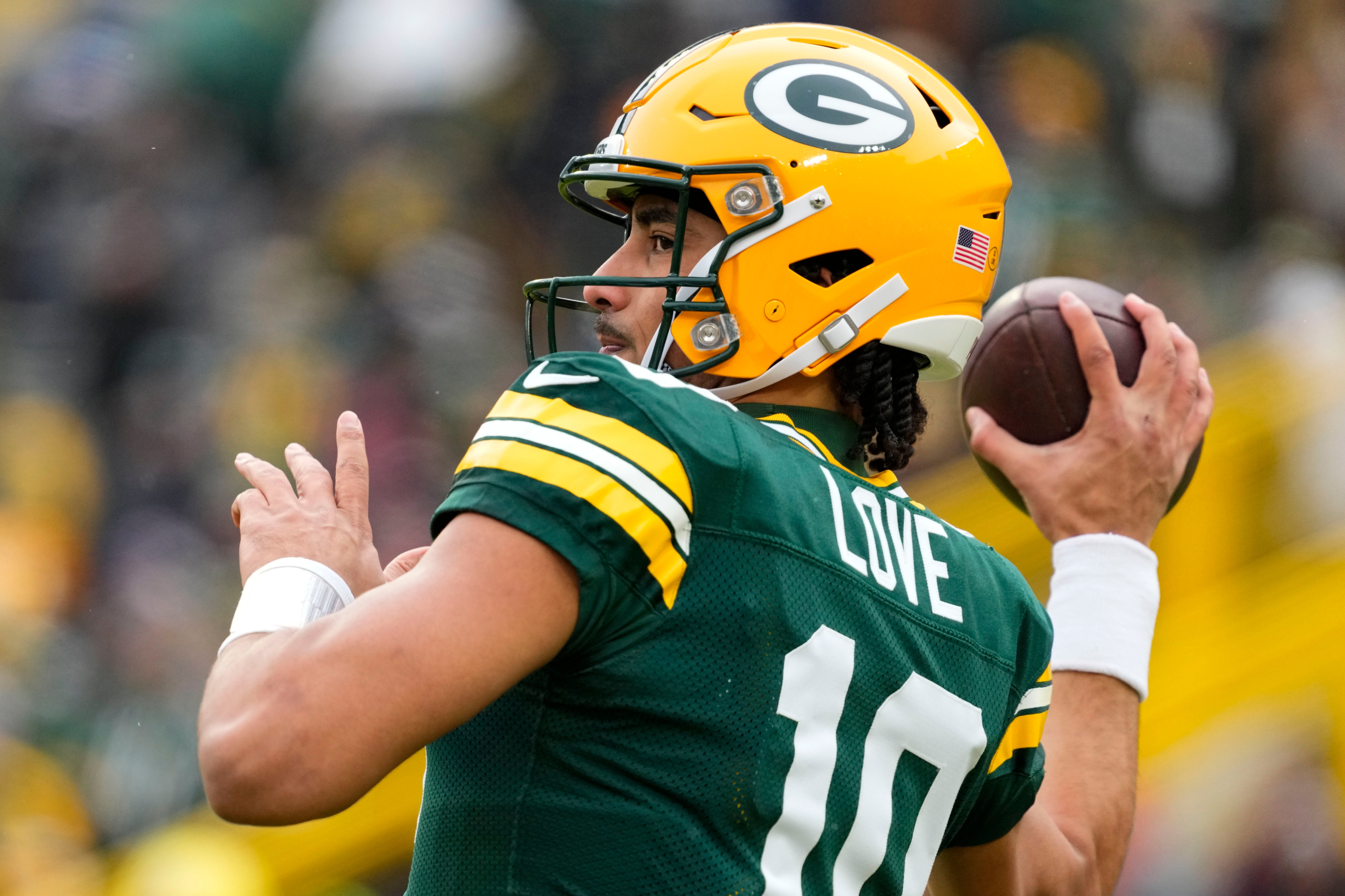 Green Bay Packers quarterback Jordan Love (10) throws a pass during warmups prior to the game against the Chicago Bears at Lambeau Field.