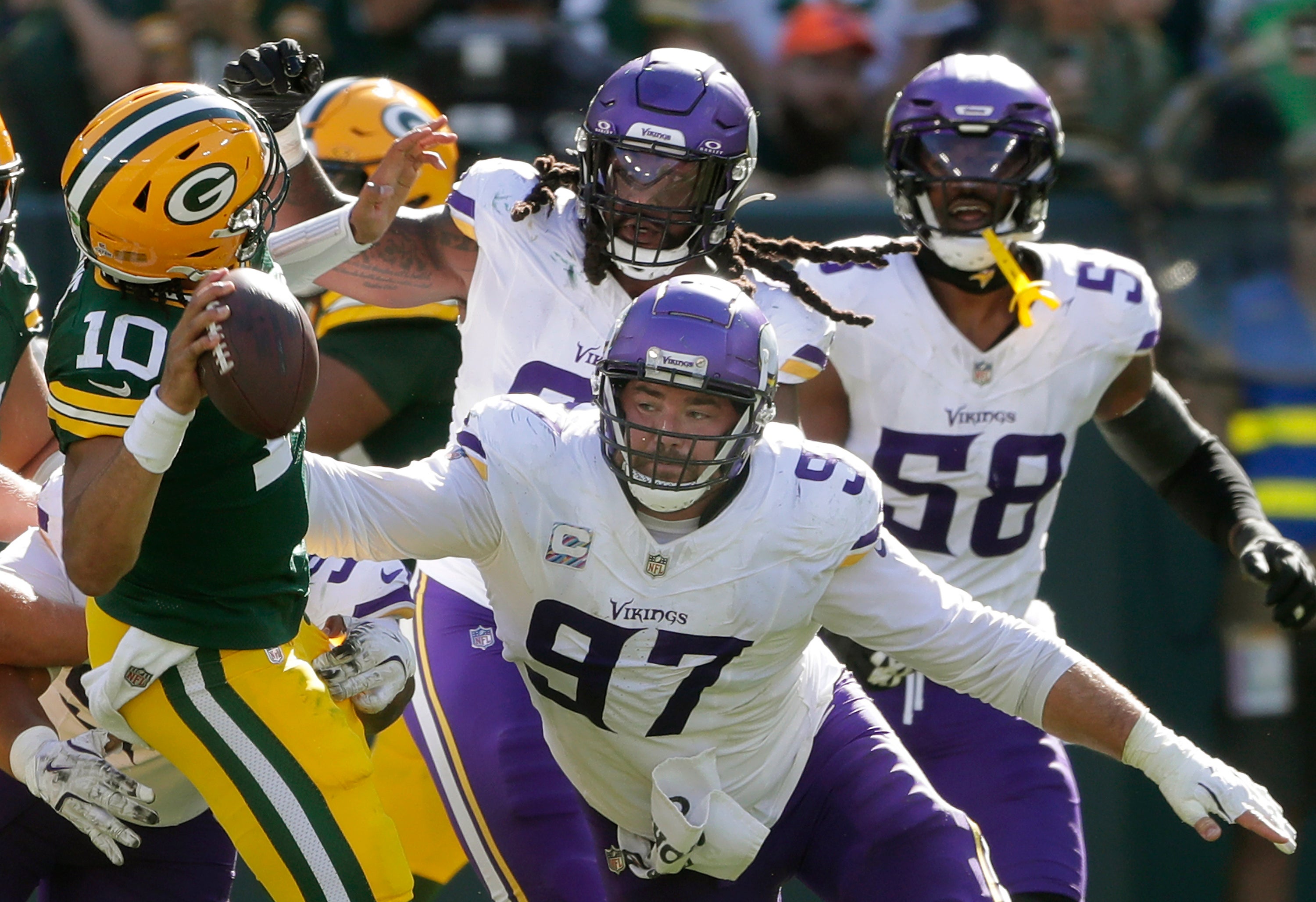 Sep 29, 2024; Green Bay, Wisconsin, USA; Minnesota Vikings defensive tackle Harrison Phillips (97) pressures Green Bay Packers quarterback Jordan Love (10) during their football game on Sunday, September 29, 2024 at Lambeau Field in Green Bay, Wis.
