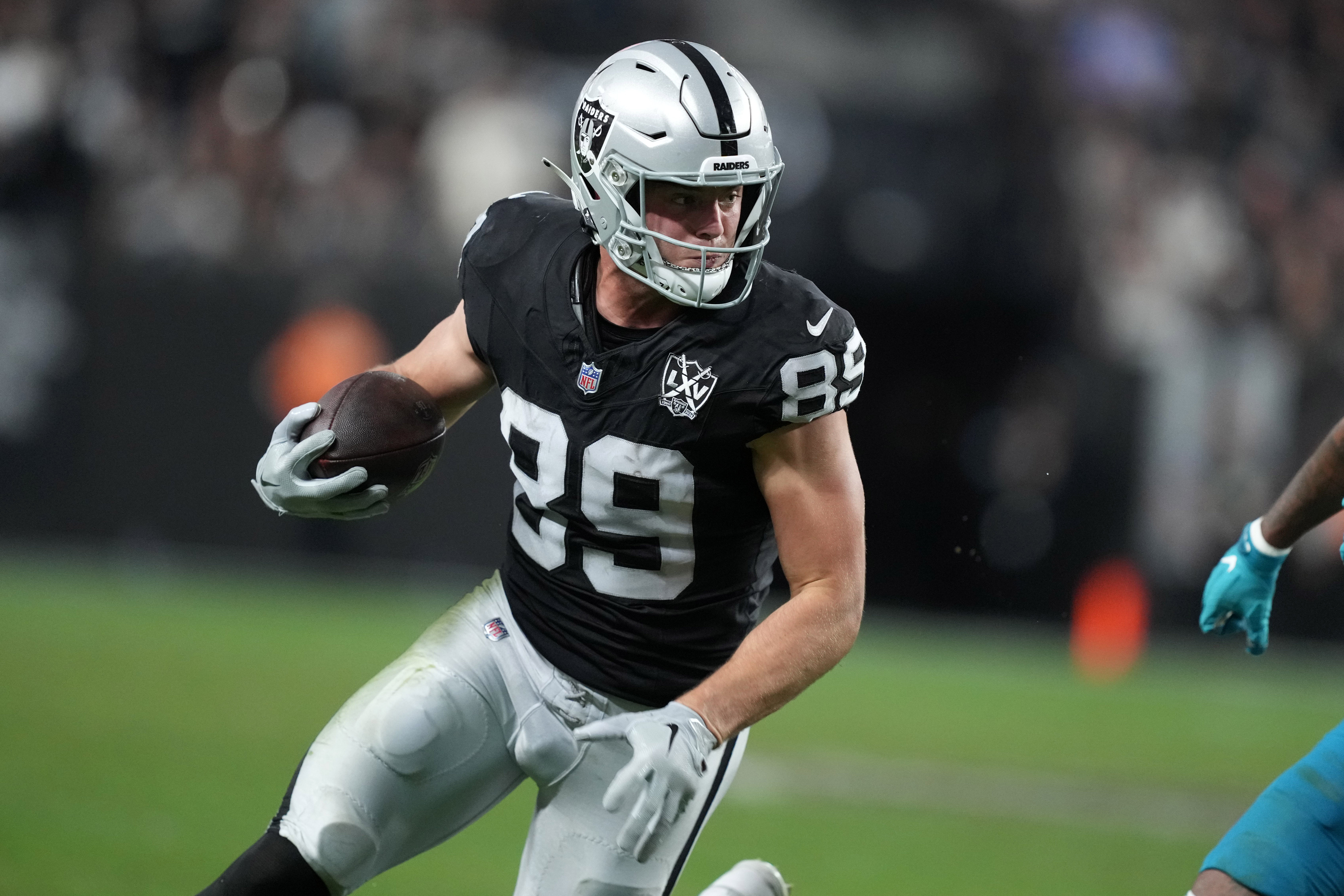 Dec 22, 2024; Paradise, Nevada, USA; Las Vegas Raiders tight end Brock Bowers (89) carries the ball against the Jacksonville Jaguars in the second half at Allegiant Stadium.
