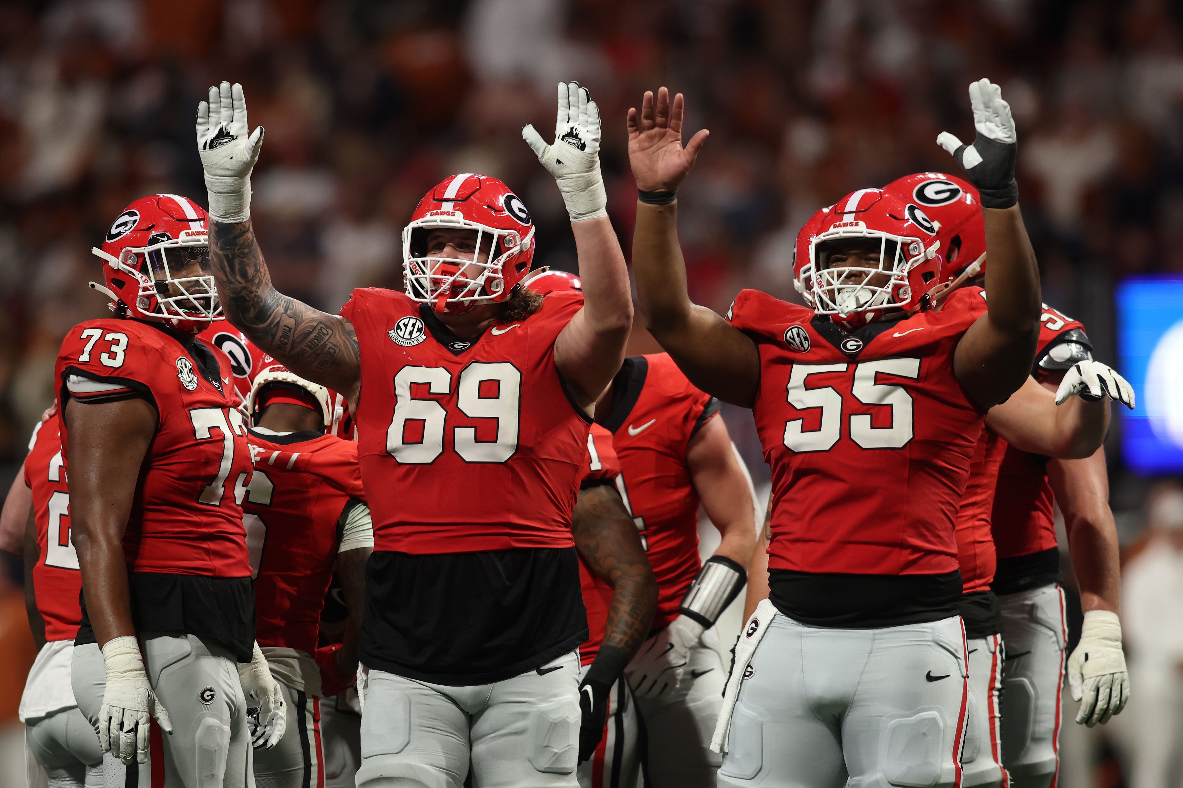 Dec 7, 2024; Atlanta, GA, USA; Georgia Bulldogs offensive lineman Tate Ratledge (69) and offensive lineman Jared Wilson (55) react during the second half in the 2024 SEC Championship game at Mercedes-Benz Stadium.