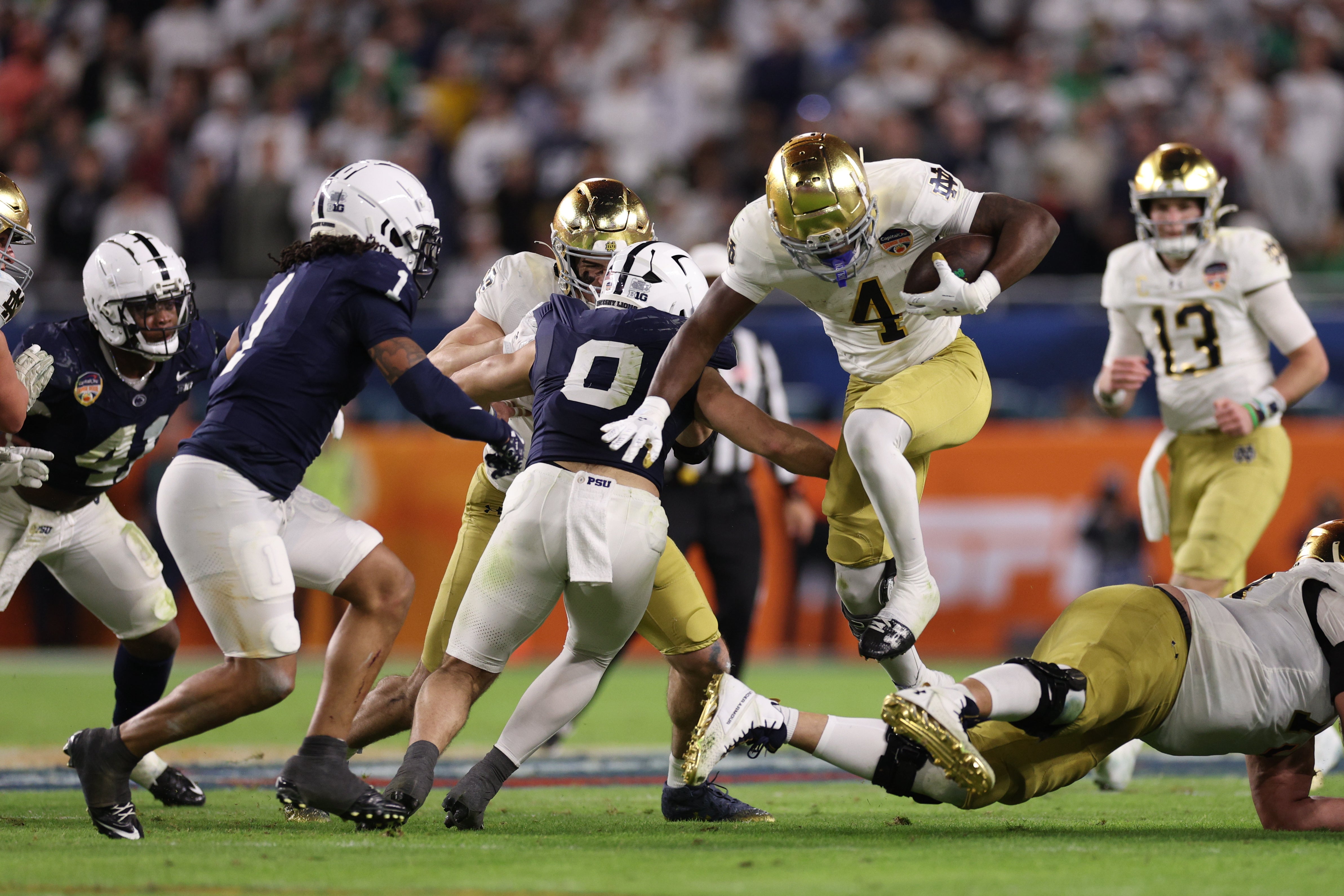 Notre Dame Fighting Irish running back Jeremiyah Love (4) runs the ball in the second half against the Penn State Nittany Lions in the Orange Bowl at Hard Rock Stadium.