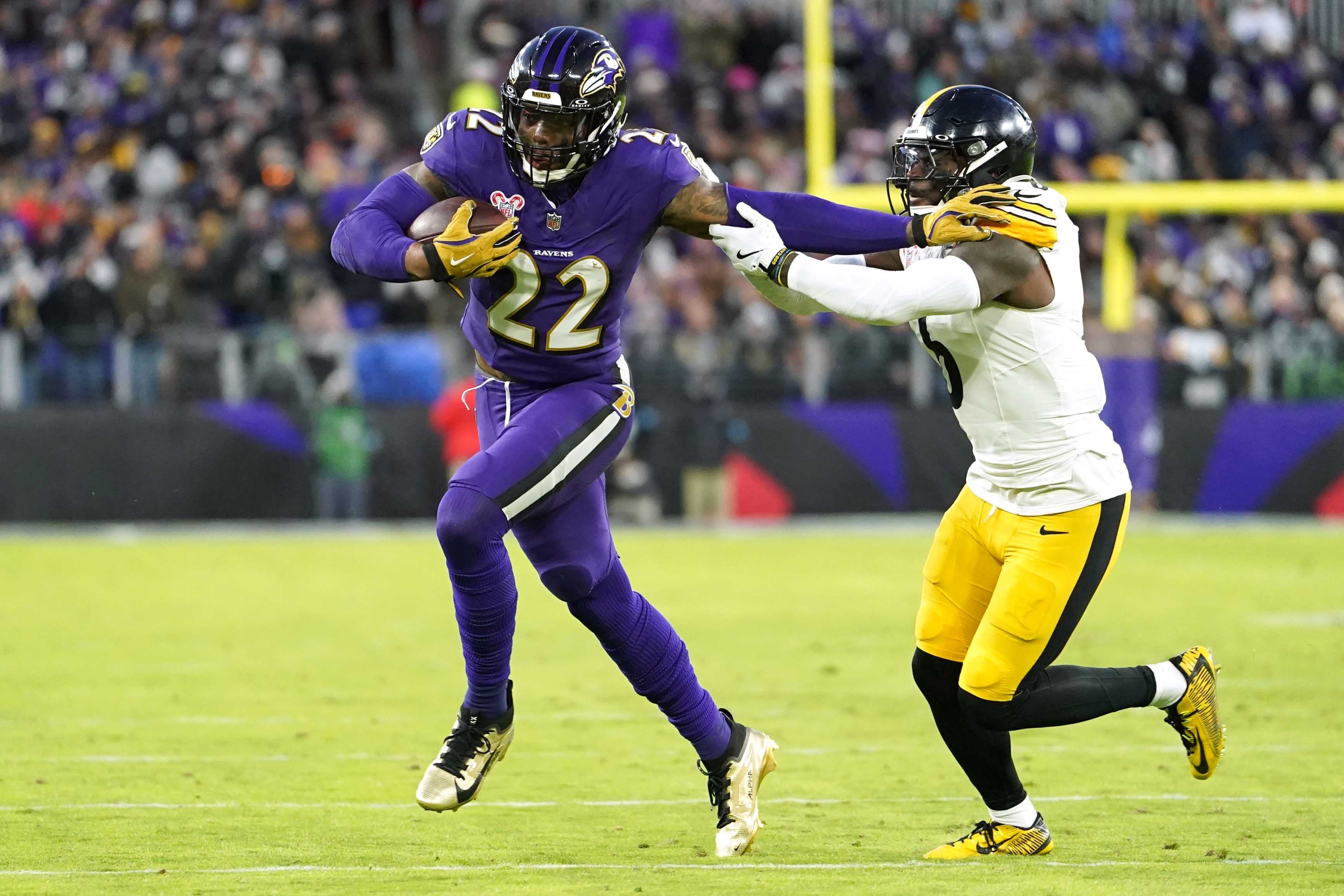 Dec 21, 2024; Baltimore, Maryland, USA; Baltimore Ravens running back Derrick Henry (22) runs for a gain defended by Pittsburgh Steelers linebacker Patrick Queen (6) in the first quarter at M&T Bank Stadium.