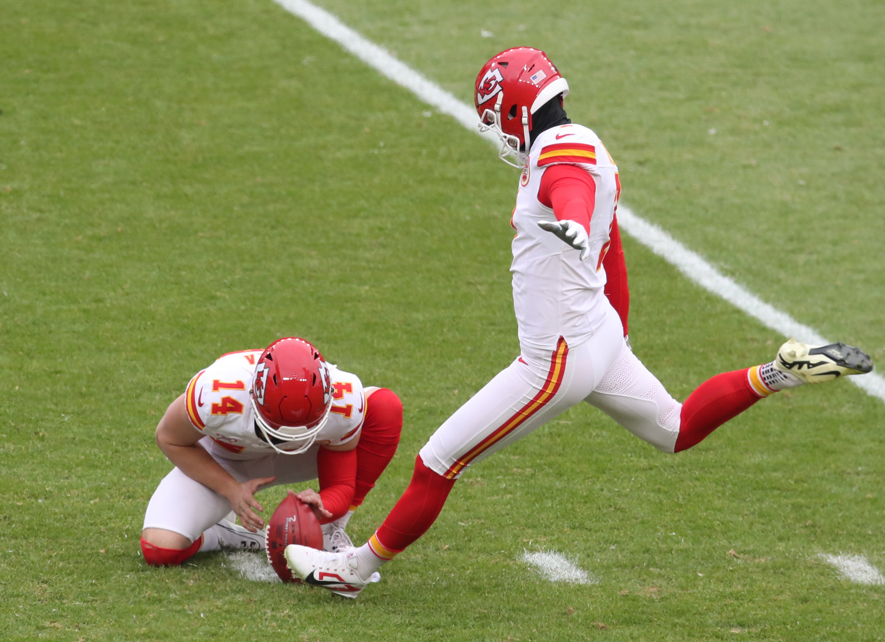 Dec 25, 2024; Pittsburgh, Pennsylvania, USA; Kansas City Chiefs place kicker Harrison Butker (7) kicks a field goal from the hold of punter Matt Araiza (14) against the Pittsburgh Steelers during the third quarter at Acrisure Stadium.