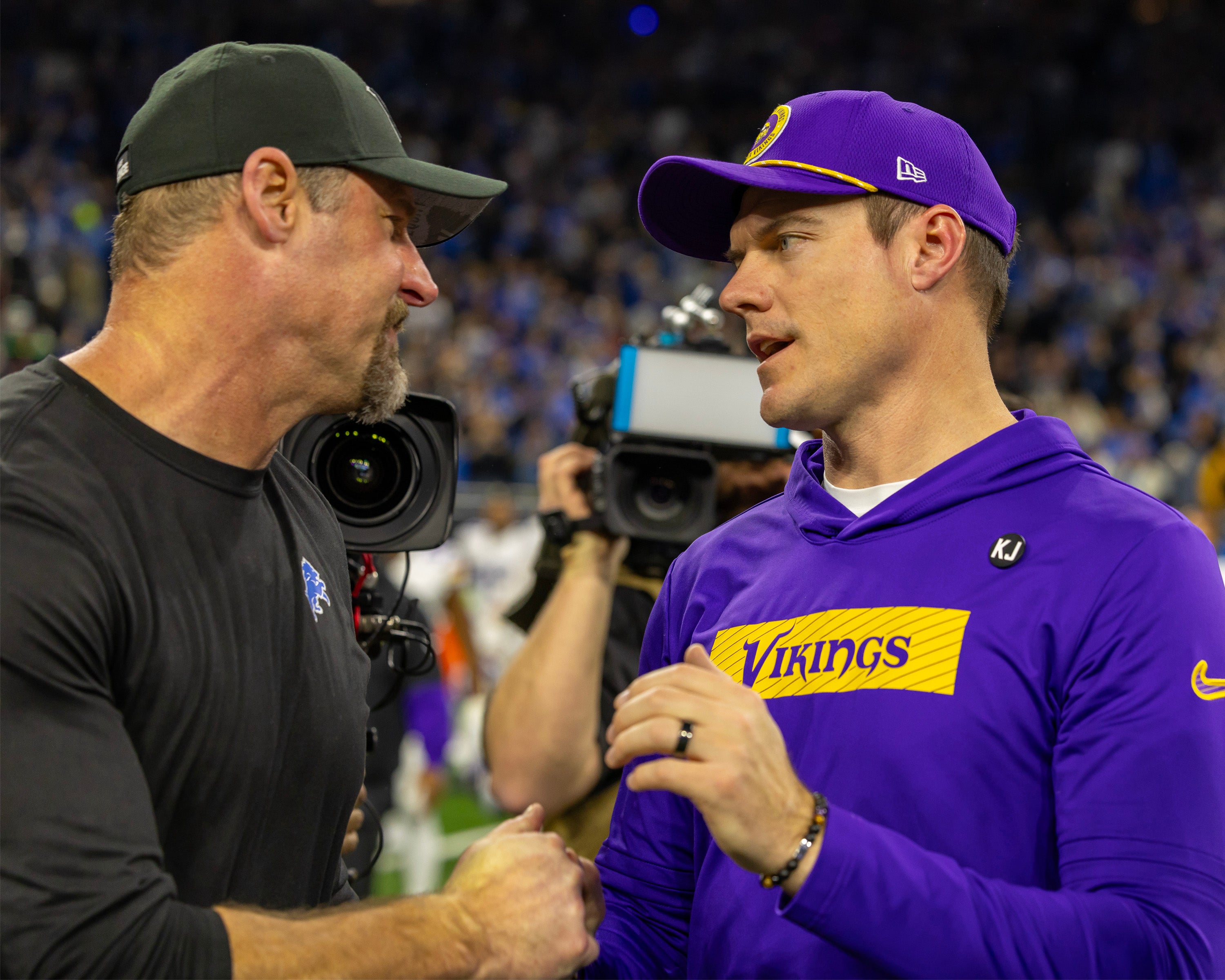 Jan 5, 2025; Detroit, Michigan, USA; Detroit Lions Head Coach Dan Campbell (L) shakes hands with Minnesota Vikings Head Coach Sean McDermott after the game at Ford Field.
