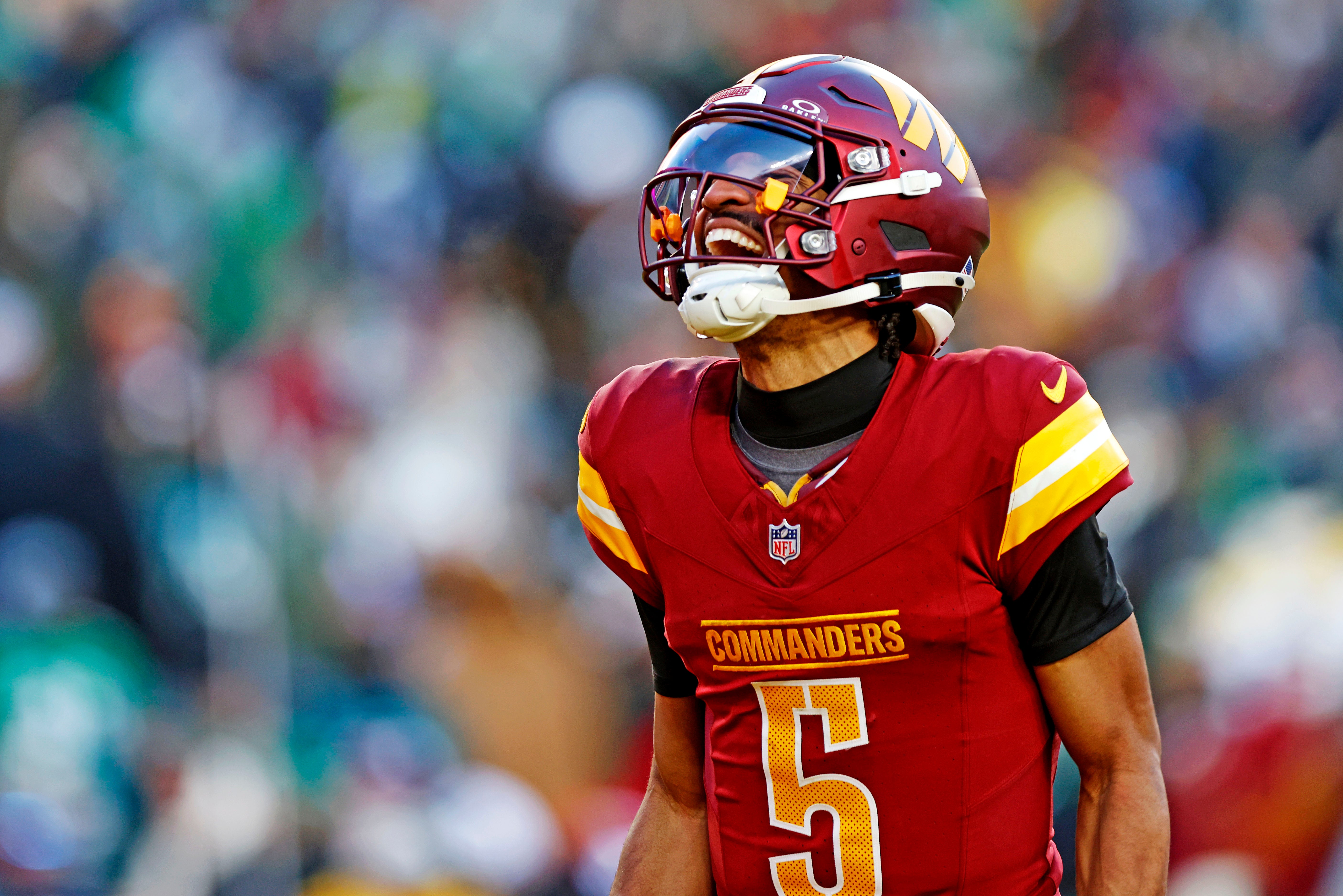 Dec 22, 2024; Landover, Maryland, USA; Washington Commanders quarterback Jayden Daniels (5) celebrates after throwing a touchdown during the fourth quarter against the Philadelphia Eagles at Northwest Stadium.