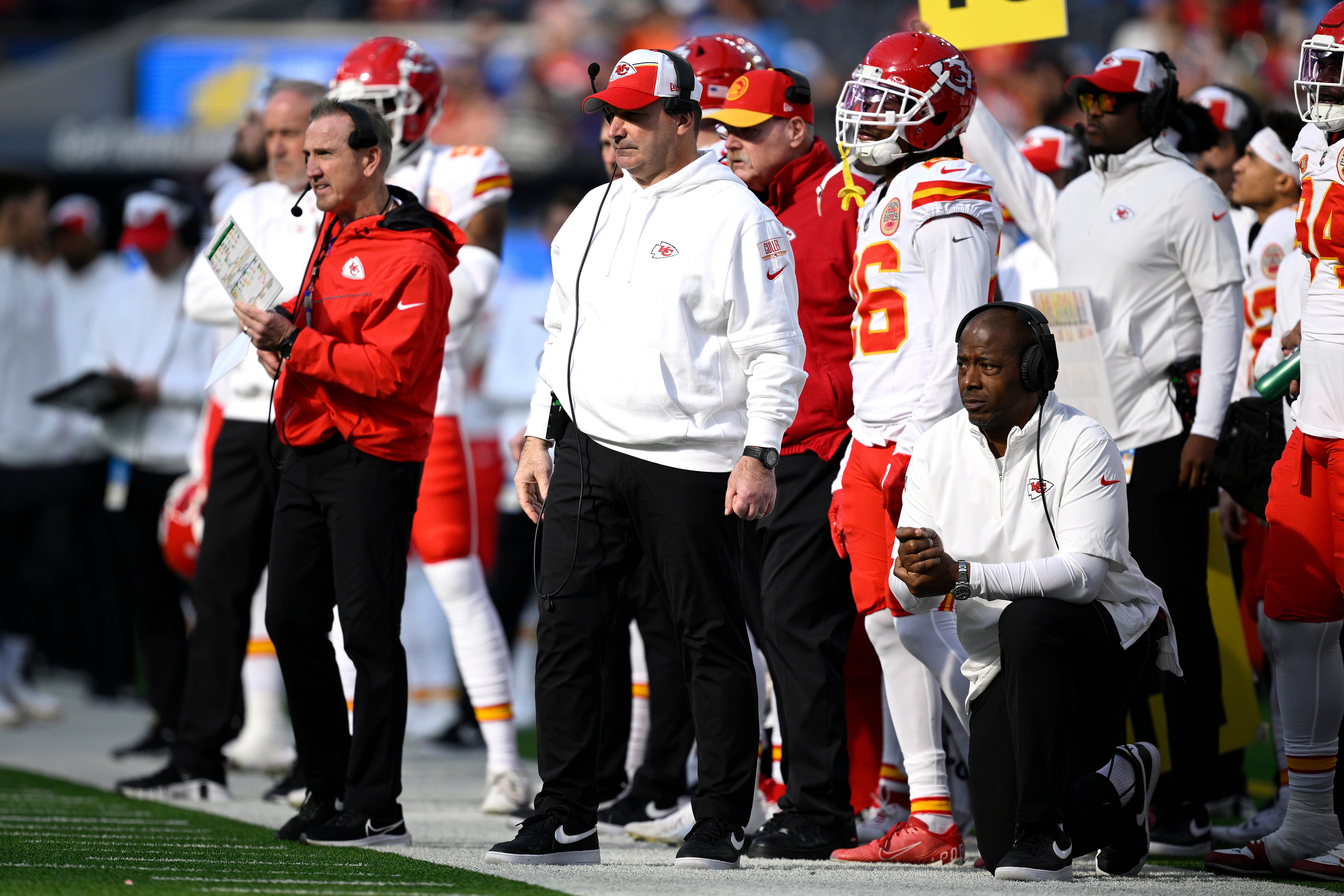 Jan 7, 2024; Inglewood, California, USA; Kansas City Chiefs defensive line coach Joe Cullen (center) looks on from the sideline alongside defensive coordinator Steve Spagnuolo (left) and defensive backs coach Dave Merritt (bottom, right) during the first half against the Los Angeles Chargers at SoFi Stadium.