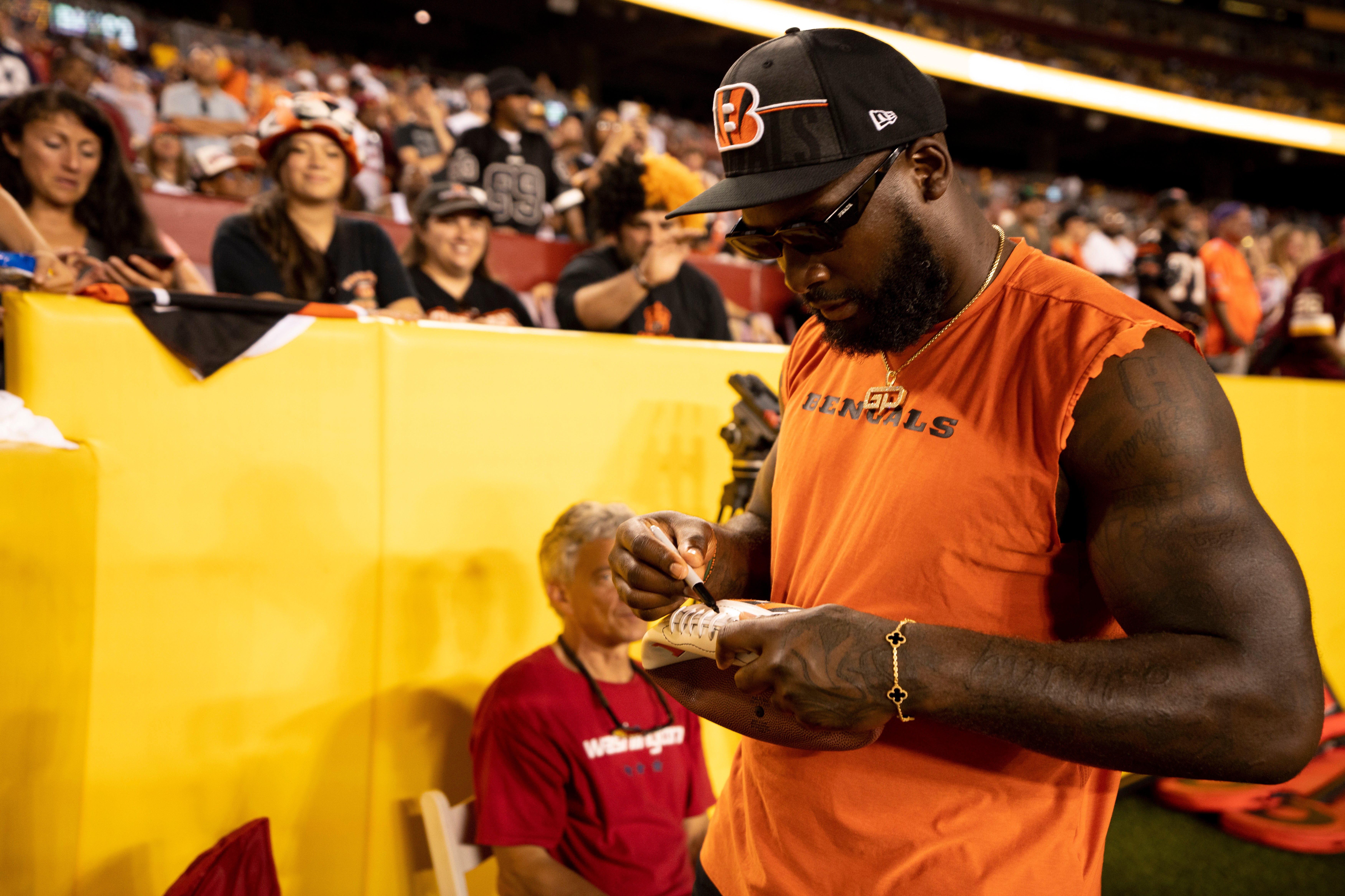 Aug 26, 2023; Landover, Maryland, USA; Cincinnati Bengals linebacker Germaine Pratt (57) signs a football for a fan in the fourth quarter of the NFL preseason week 3 game between the Cincinnati Bengals and the Washington Commanders at FedEx Field.