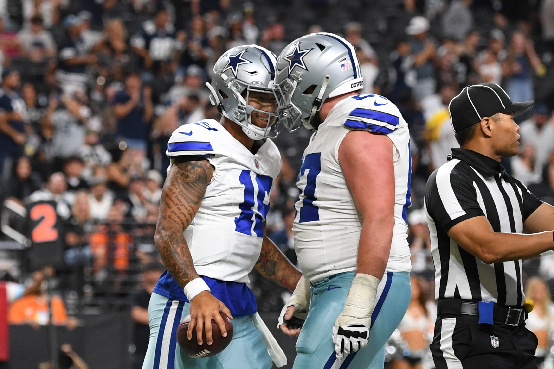 Dallas Cowboys quarterback Trey Lance (19) celebrates his touchdown with center Brock Hoffman (67) against the Las Vegas Raiders in the fourth quarter at Allegiant Stadium.