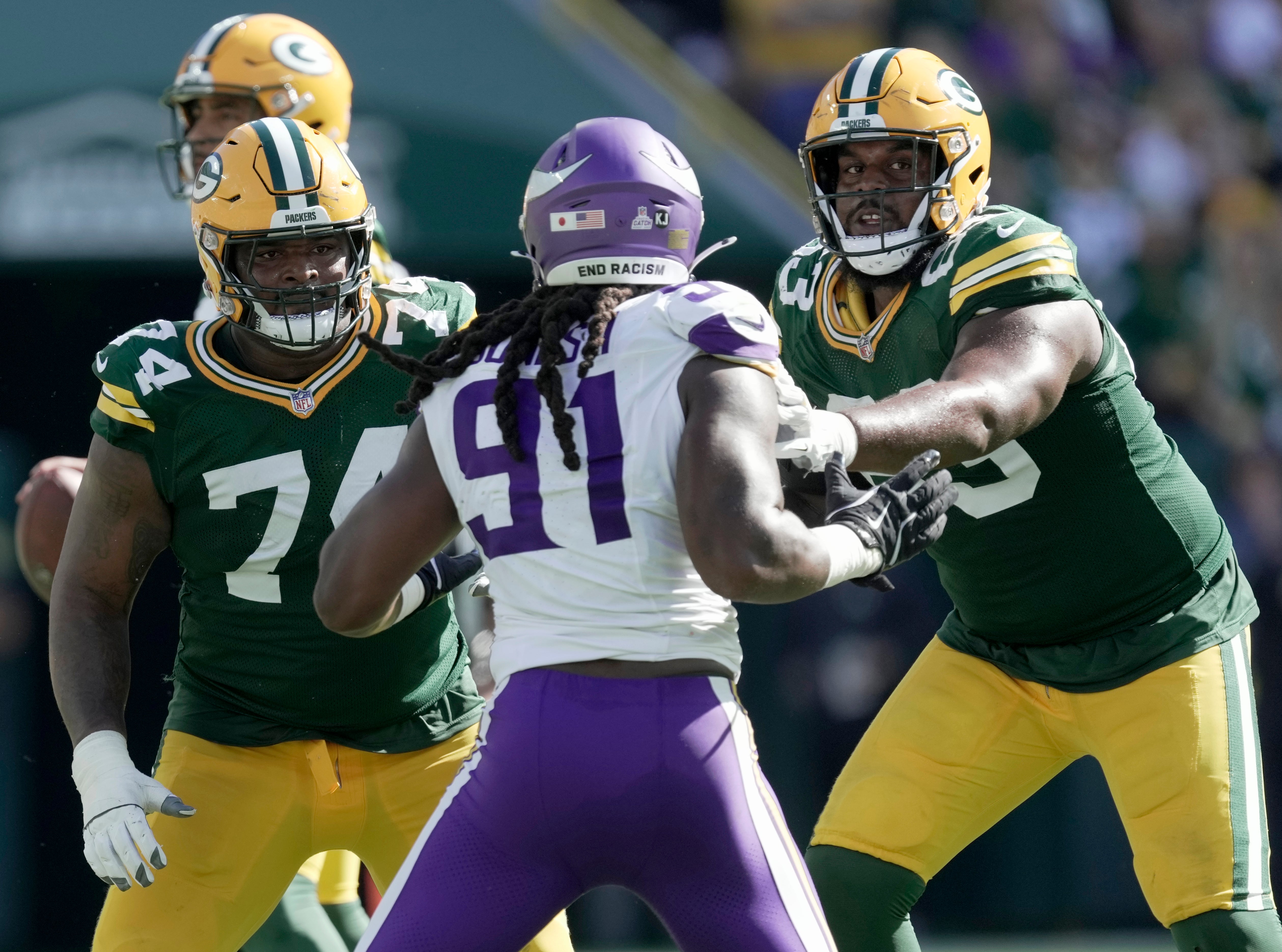 Sep 29, 2024; Green Bay, Wisconsin, USA; Green Bay Packers guard Elgton Jenkins (74) and offensive tackle Rasheed Walker (63) block Minnesota Vikings linebacker Pat Jones II (91) during the third quarter of their game Sunday, September 29, 2024 at Lambeau Field in Green Bay, Wisconsin.