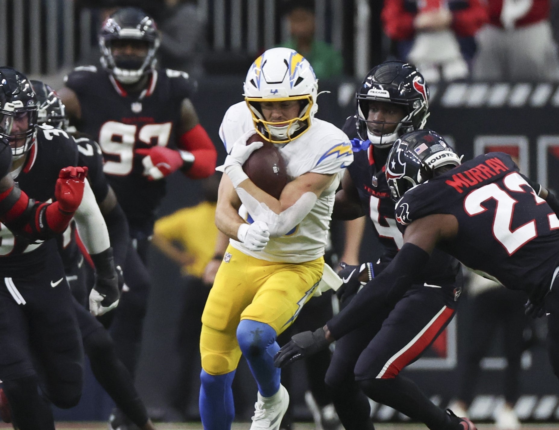 Jan 11, 2025; Houston, Texas, USA; Los Angeles Chargers wide receiver Ladd McConkey (15) is tackled by Houston Texans safety Eric Murray (23) after the catch and run in the second quarter in an AFC wild card game at NRG Stadium.