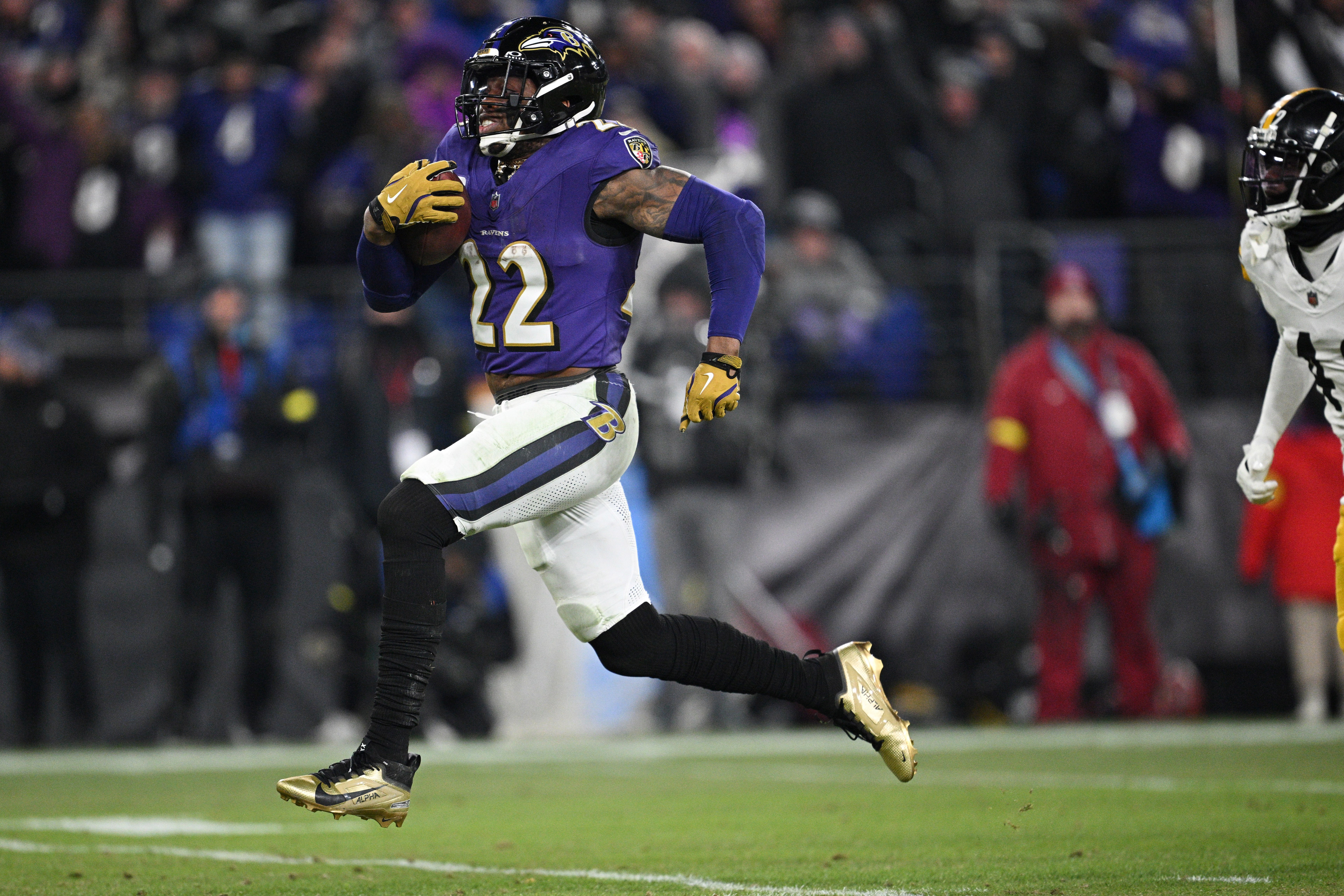 Jan 11, 2025; Baltimore, Maryland, USA; Baltimore Ravens running back Derrick Henry (22) runs to score a touchdown against the Pittsburgh Steelers in the third quarter in an AFC wild card game at M&T Bank Stadium.
