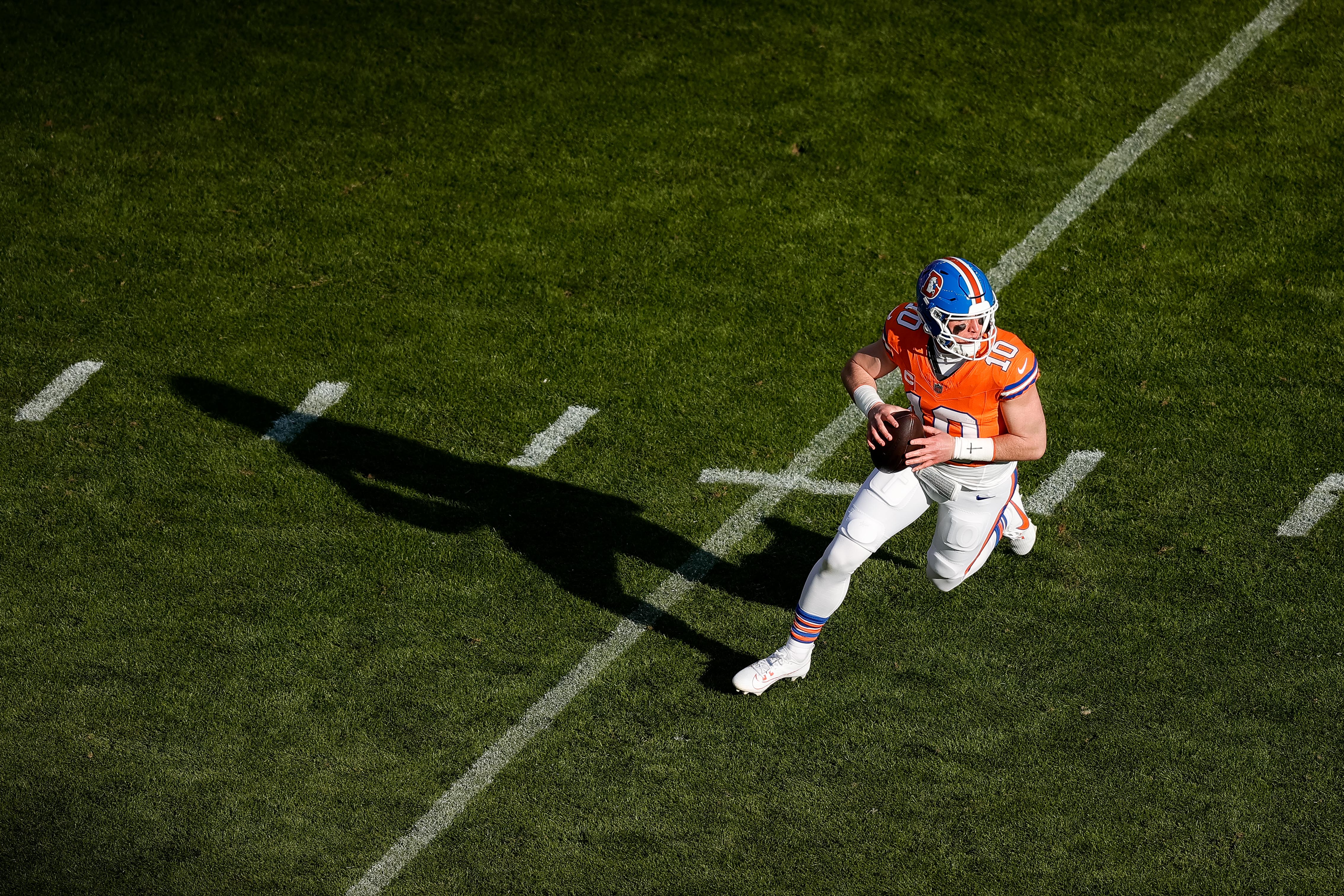 Jan 5, 2025; Denver, Colorado, USA; Denver Broncos quarterback Bo Nix (10) looks to pass in the first quarter against the Kansas City Chiefs at Empower Field at Mile High.