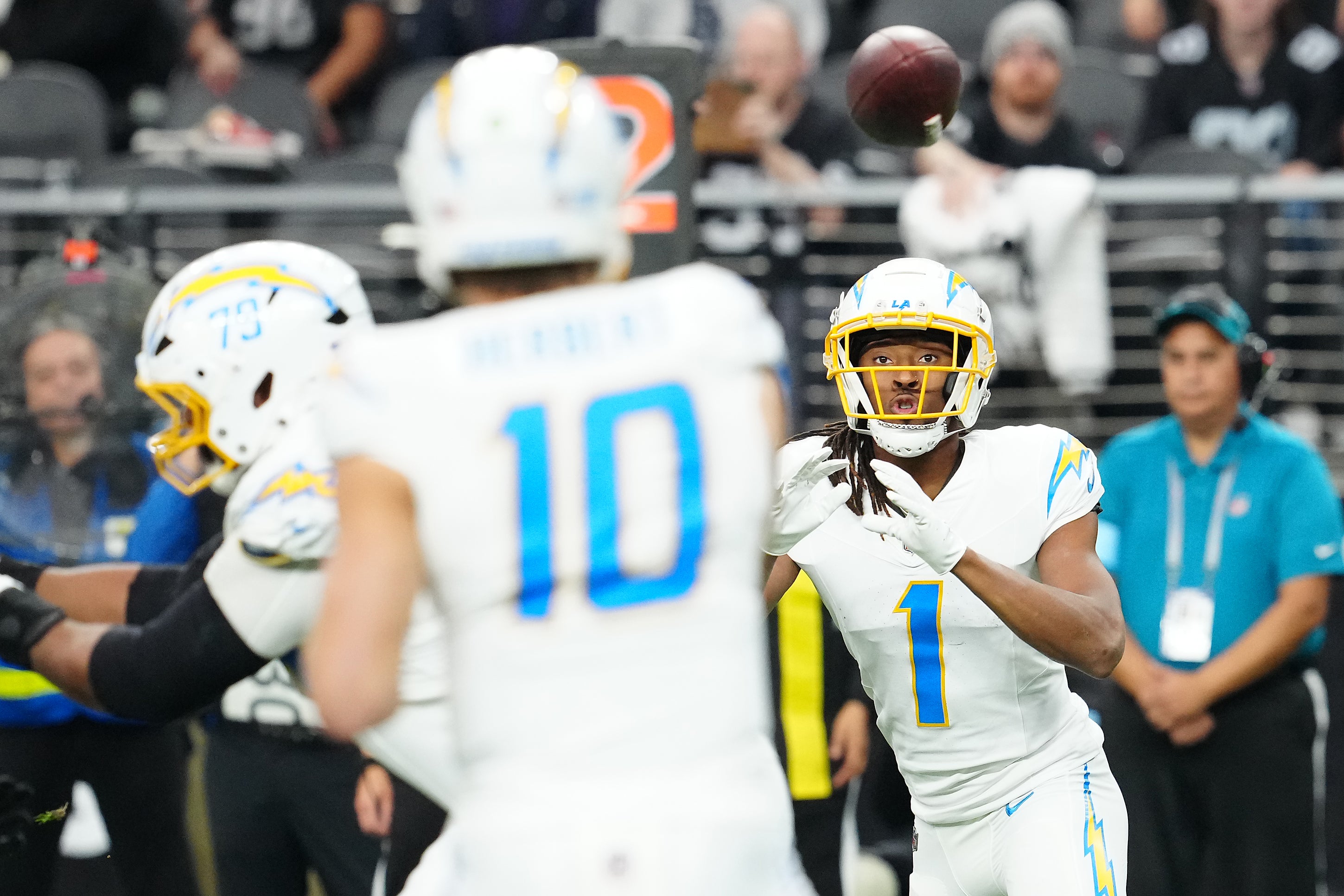 Jan 5, 2025; Paradise, Nevada, USA; Los Angeles Chargers wide receiver Quentin Johnston (1) looks to catch a pass against the Las Vegas Raiders from Los Angeles Chargers quarterback Justin Herbert (10) during the first quarter at Allegiant Stadium.