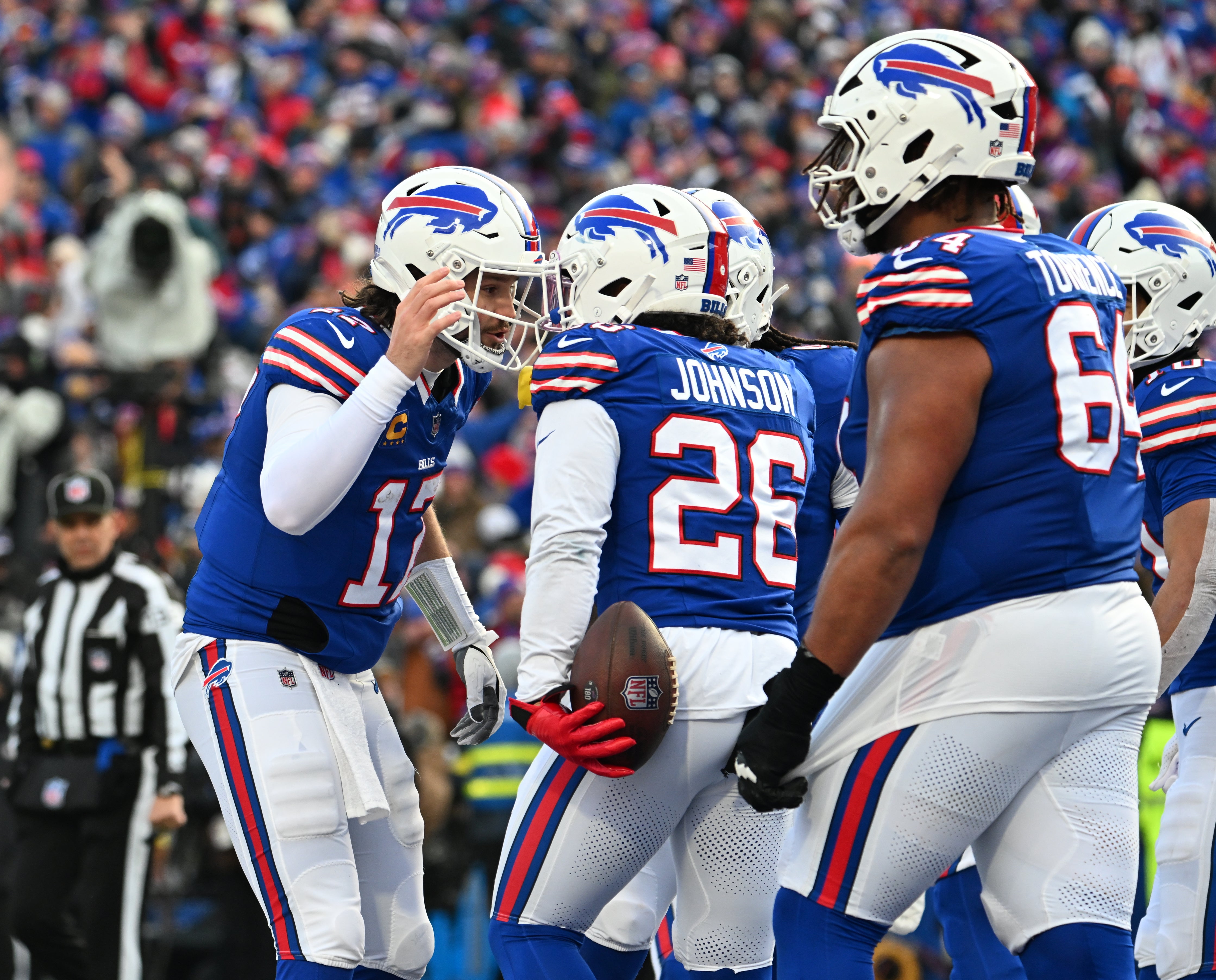 Buffalo Bills quarterback Josh Allen (17) celebrates a touchdown with running back Ty Johnson (26) during the third quarter against the Denver Broncos in an AFC wild card game at Highmark Stadium.