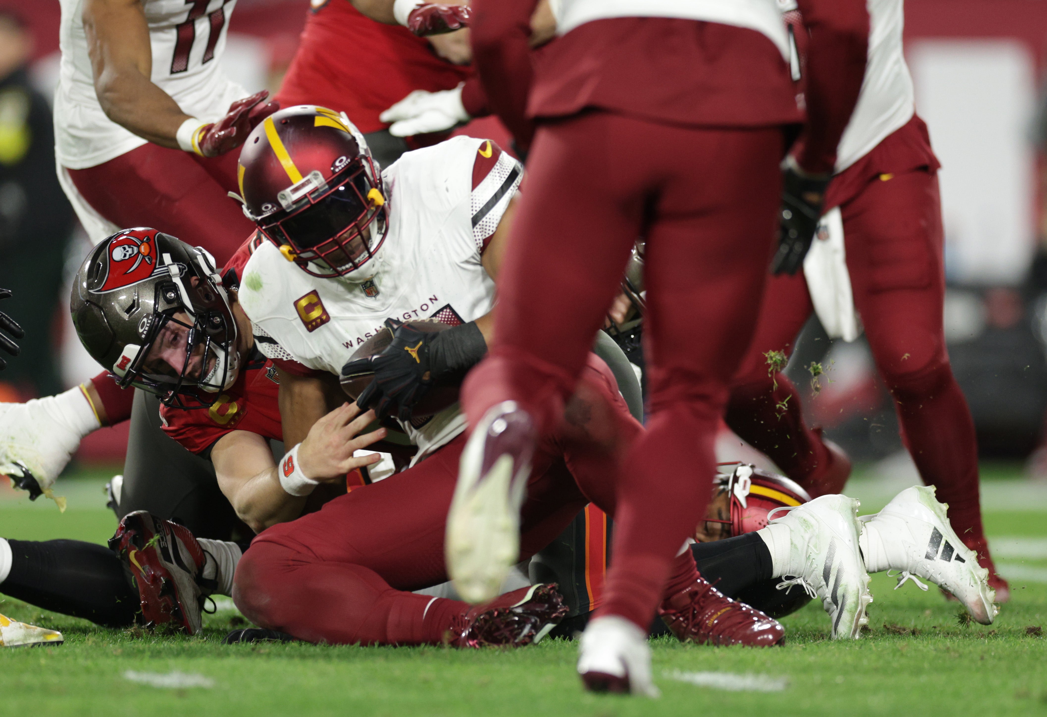 Jan 12, 2025; Tampa, Florida, USA; Washington Commanders linebacker Bobby Wagner (54) recovers a fumble by Tampa Bay Buccaneers quarterback Baker Mayfield (6) during the fourth quarter of a NFC wild card playoff at Raymond James Stadium.