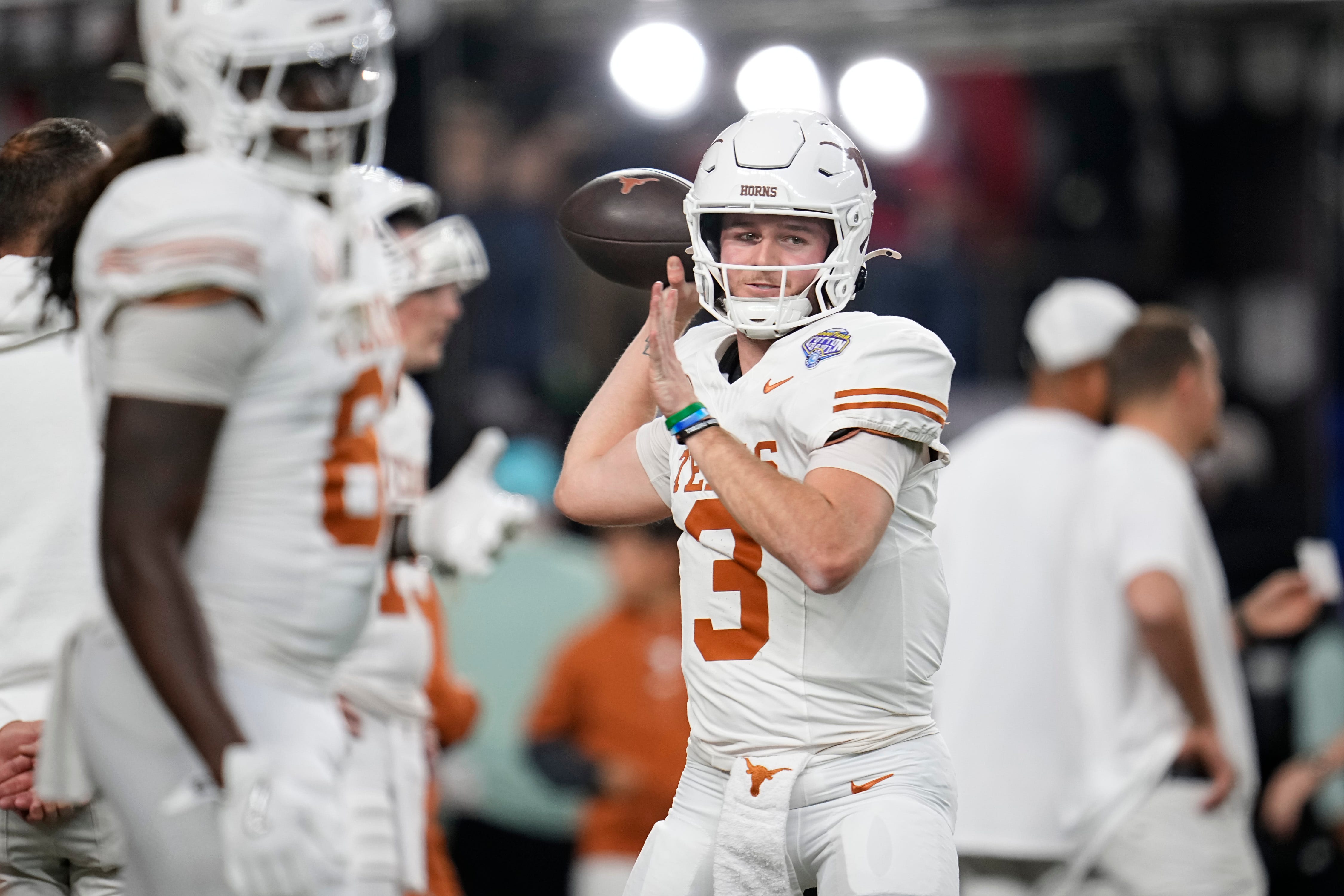 Texas Longhorns quarterback Quinn Ewers (3) warms up prior to the Cotton Bowl Classic College Football Playoff semifinal game between the Ohio State Buckeyes and the Texas Longhorns at AT&T Stadium in Arlington, Texas on Jan. 10, 2025.
