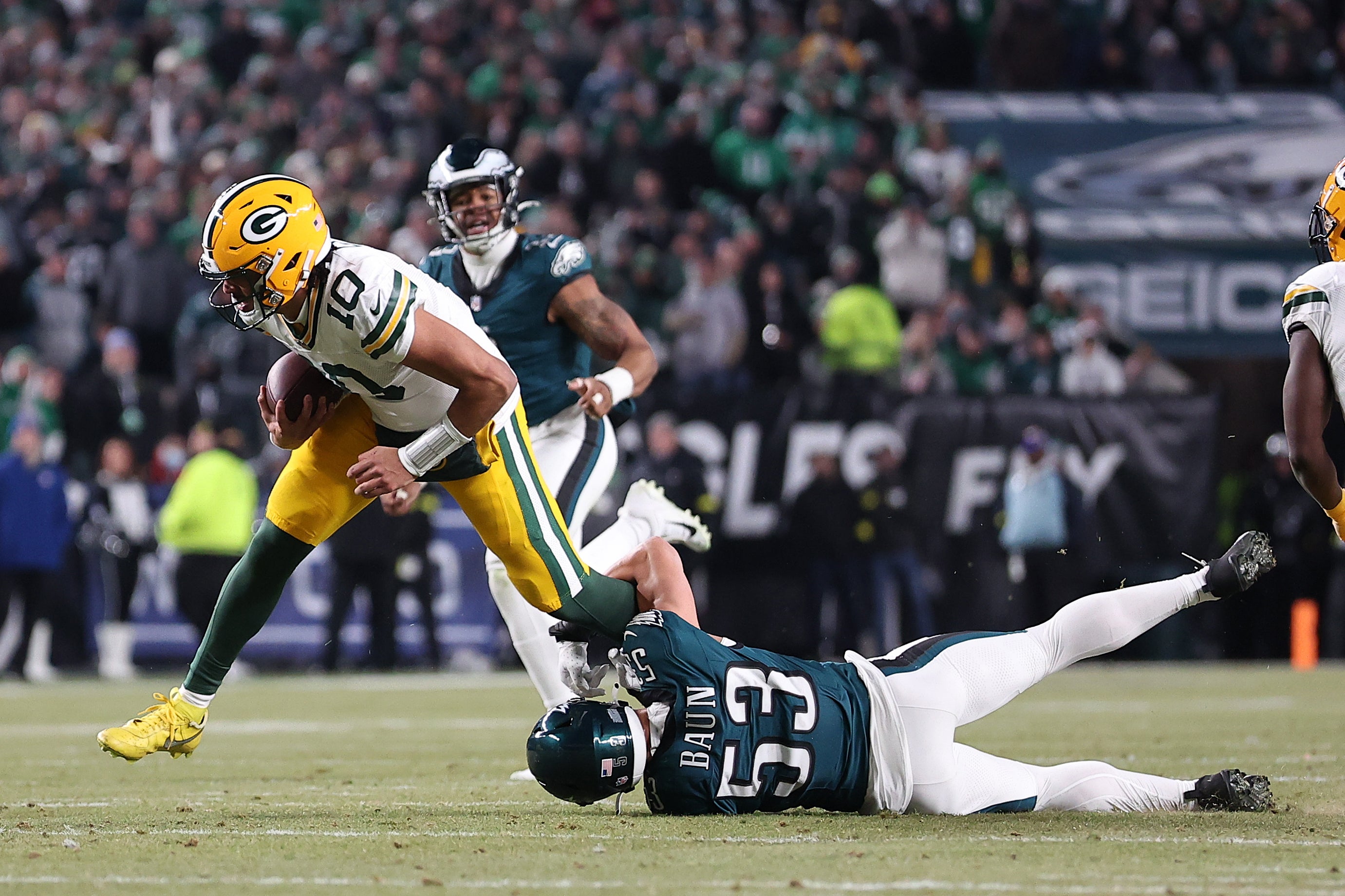 Green Bay Packers quarterback Jordan Love (10) breaks the tackle of Philadelphia Eagles linebacker Zack Baun (53) during the first half in an NFC wild card game at Lincoln Financial Field.