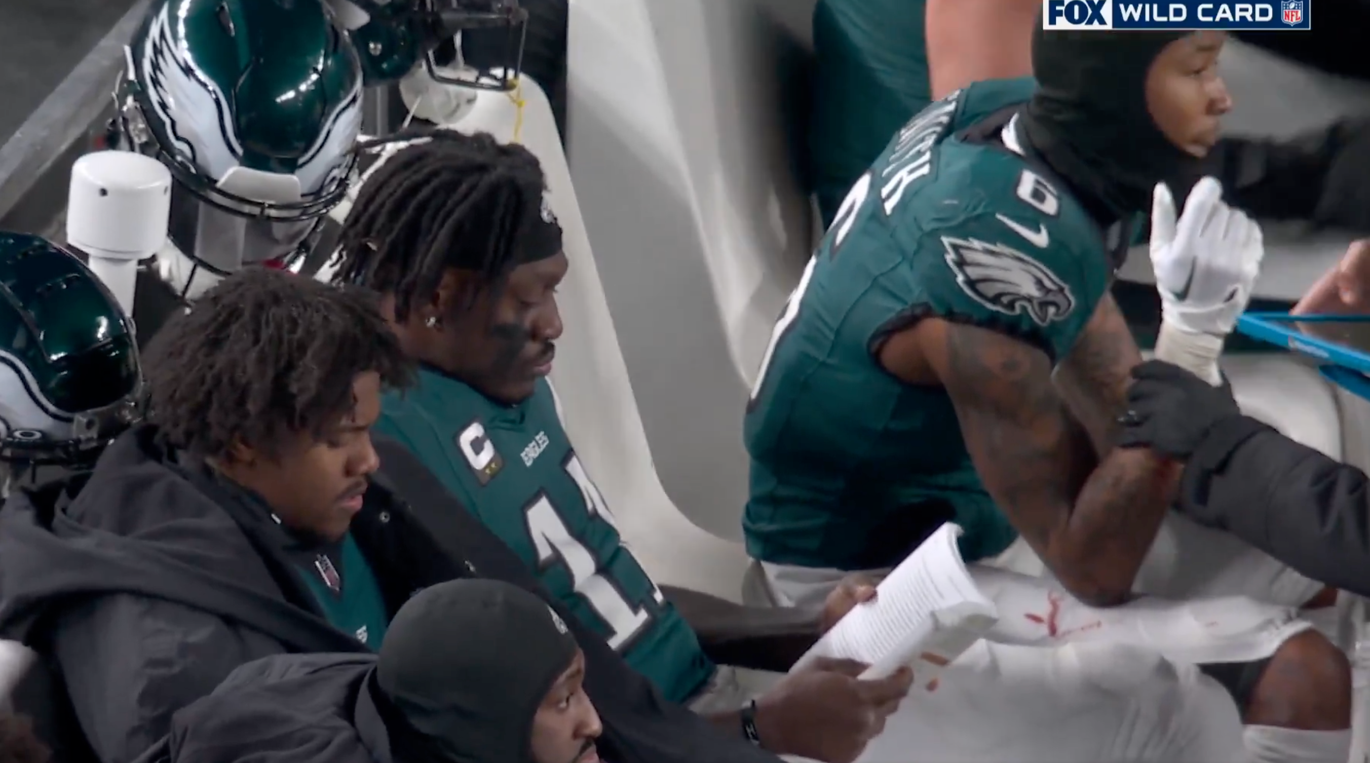 Philadelphia Eagles wide receiver A.J. Brown reads a book on the bench during wild card matchup vs. Green Bay Packers.