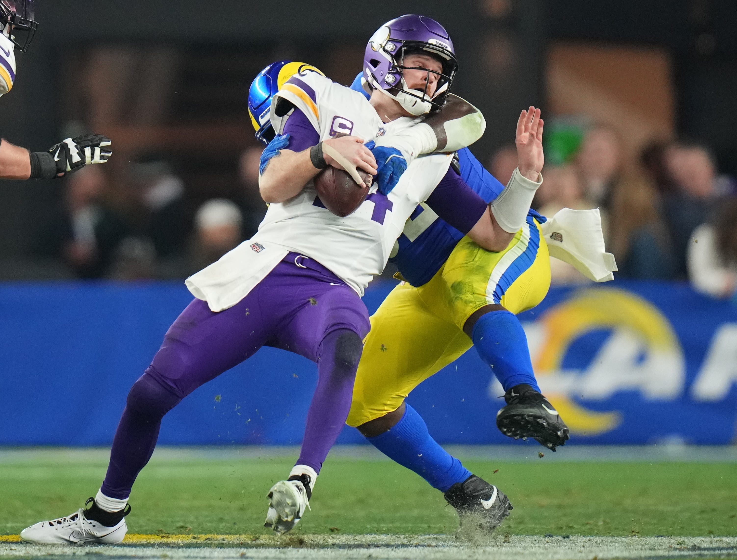 Los Angeles Rams defensive lineman Neville Gallimore (92) sacks Minnesota Vikings quarterback Sam Darnold (14) during their playoff game at State Farm Stadium on Jan. 13, 2025, in Glendale.