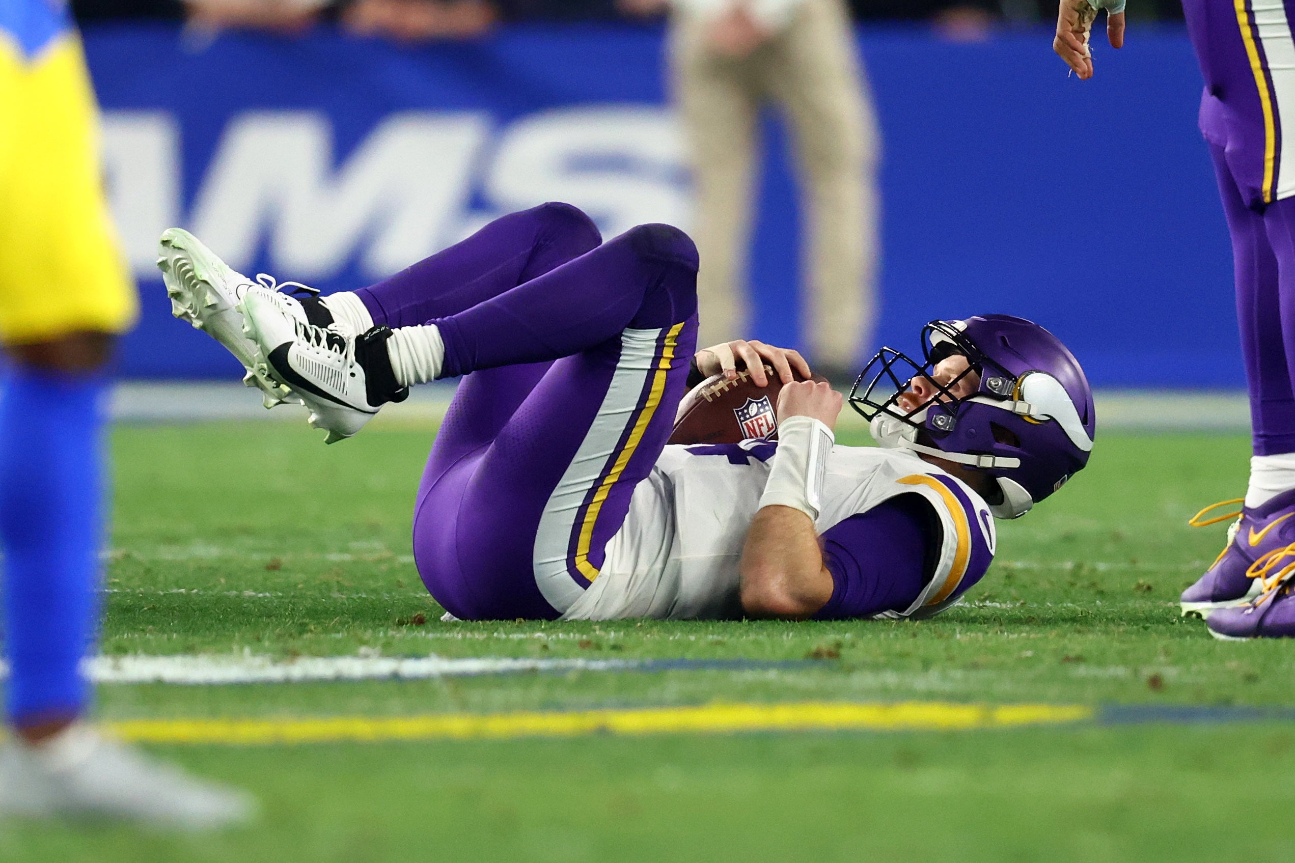 Minnesota Vikings quarterback Sam Darnold (14) is sacked against the Los Angeles Rams during the first half in an NFC wild card game at State Farm Stadium.