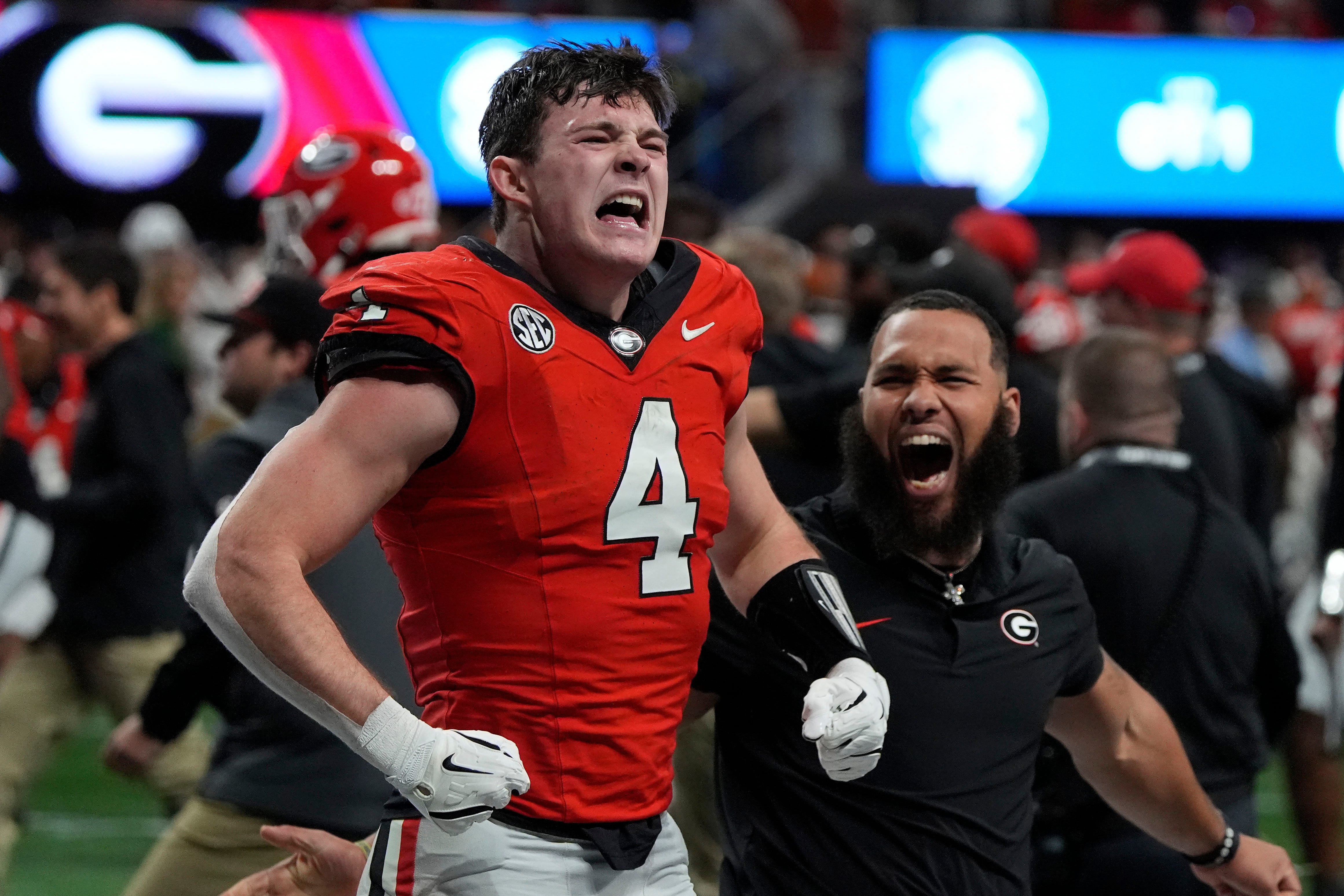 Georgia tight end Oscar Delp (4) celebrates after Georgia won in overtime of the SEC championship game against Texas in Atlanta, on Saturday, Dec. 7, 2024. Georgia won 22-19