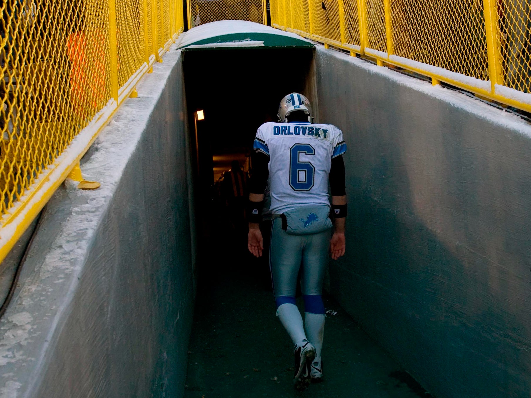 Detroit Lions quarterback Dan Orlovsky (6) walks up the tunnel to the locker room following the game against the Green Bay Packers at Lambeau Field. The Packers defeated the Lions 31-21.