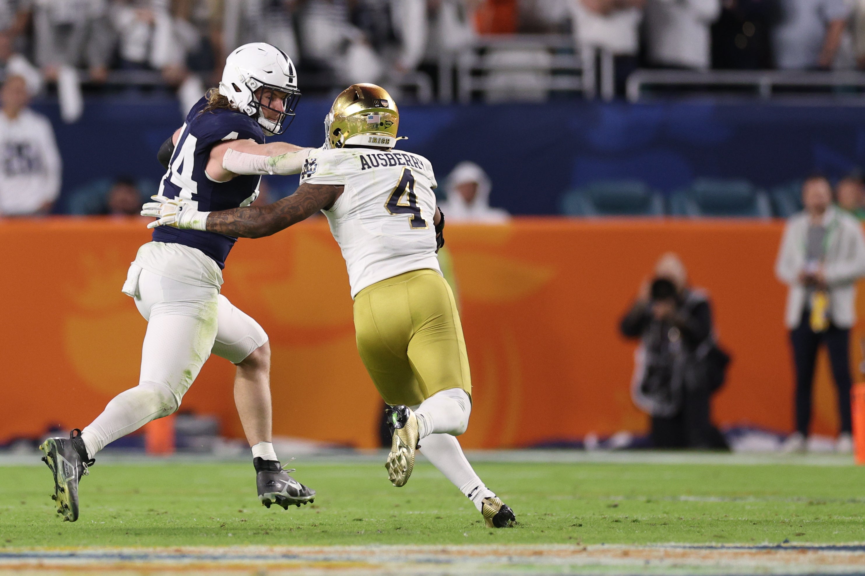 Penn State Nittany Lions tight end Tyler Warren (44) holds off Notre Dame Fighting Irish linebacker Jaiden Ausberry (4) in the first half in the Orange Bowl at Hard Rock Stadium.