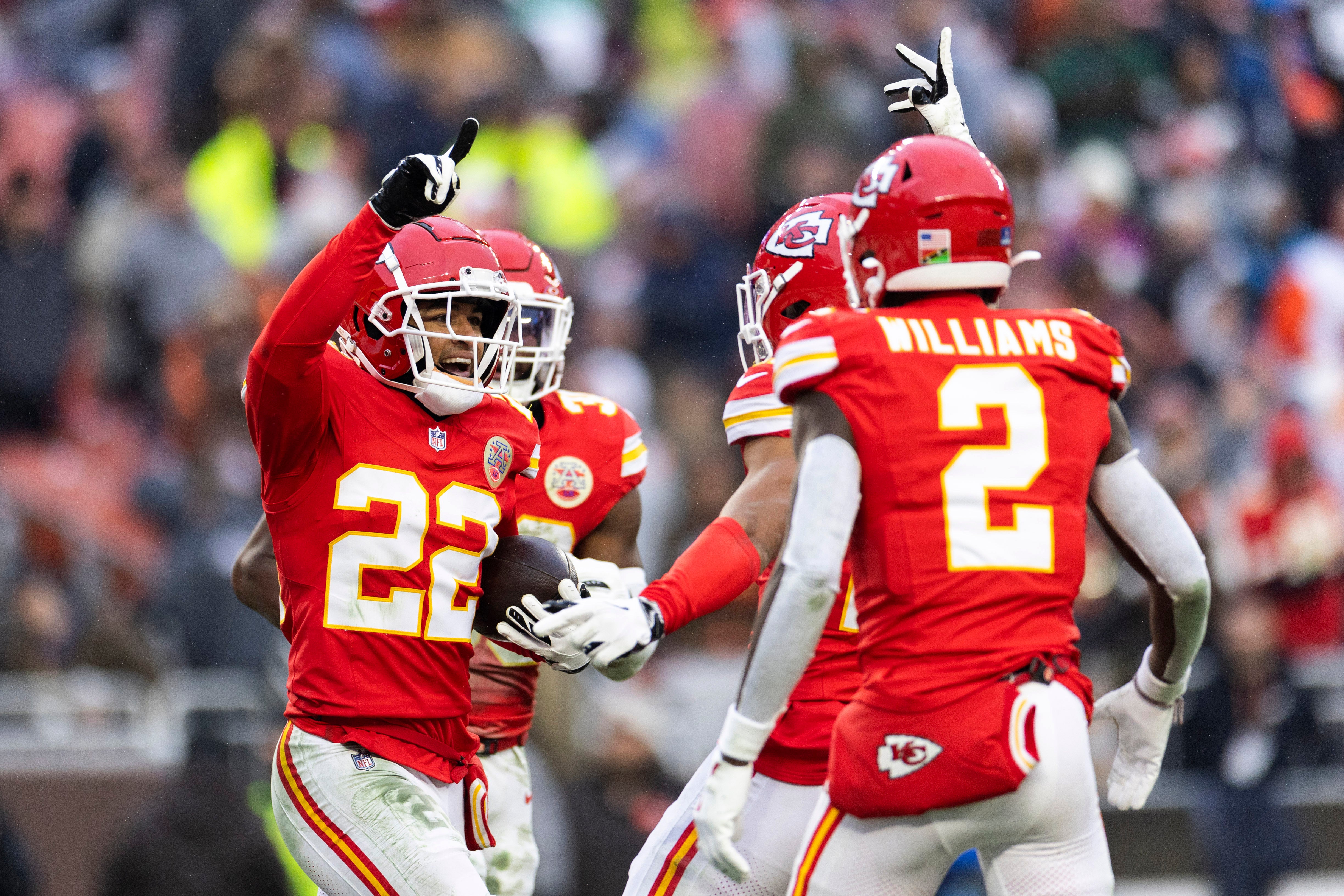 Chiefs cornerback Trent McDuffie (22) celebrates his interception with teammates against the Browns