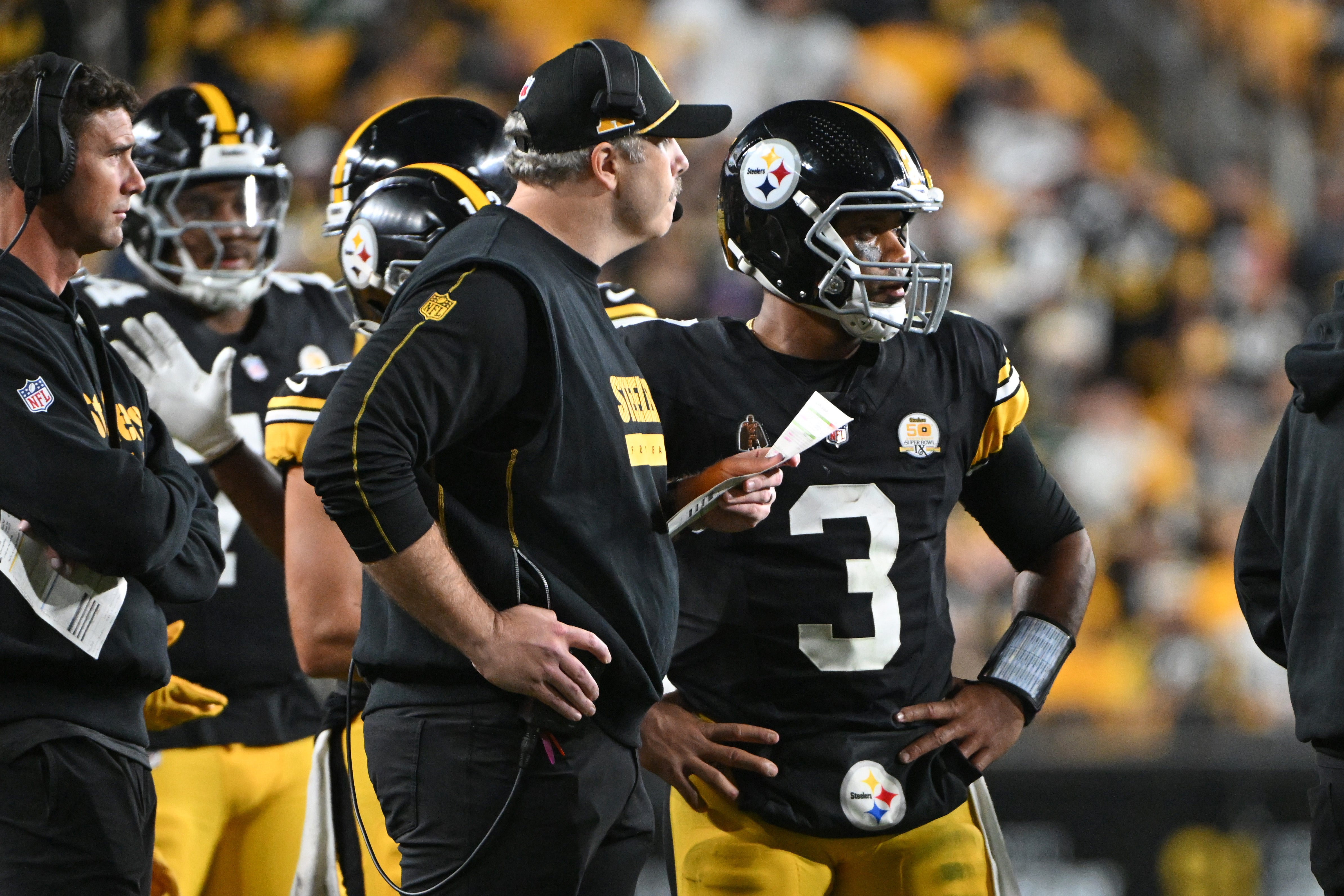 Oct 20, 2024; Pittsburgh, Pennsylvania, USA; Pittsburgh Steelers offensive coordinator Arthur Smith talks with quarterback Russell Wilson (3) against the New York Jets during the fourth quarter at Acrisure Stadium.