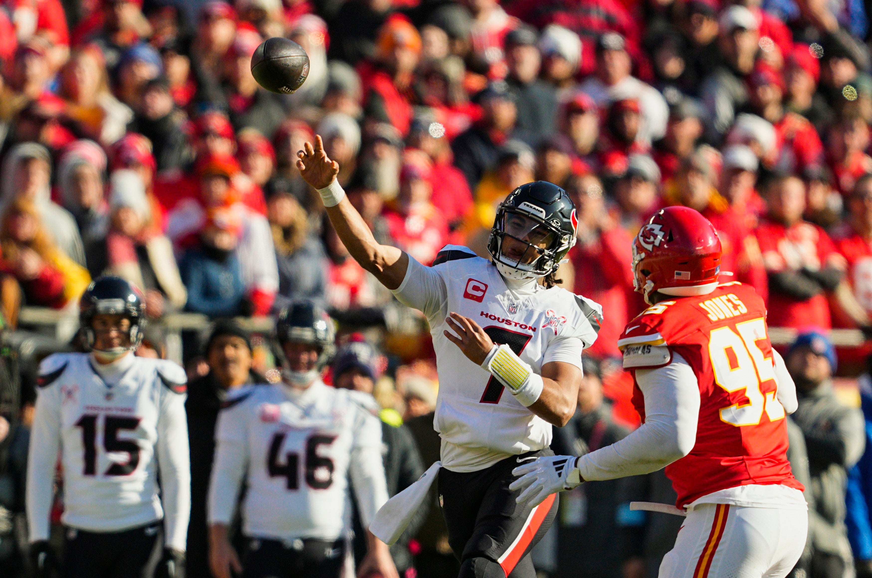 Dec 21, 2024; Kansas City, Missouri, USA; Houston Texans quarterback C.J. Stroud (7) throws a pass against Kansas City Chiefs defensive tackle Chris Jones (95) during the first half at GEHA Field at Arrowhead Stadium.
