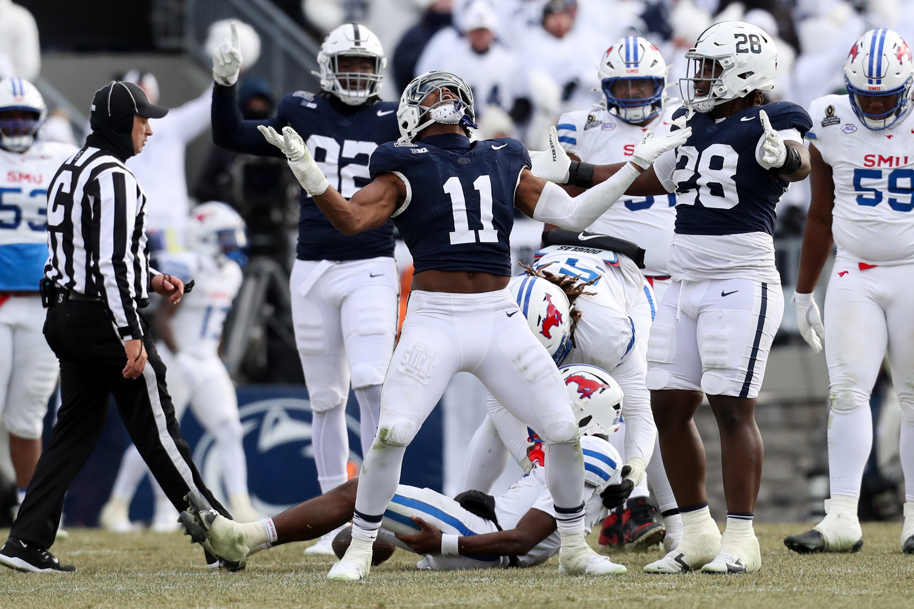 Dec 21, 2024; University Park, Pennsylvania, USA; Penn State Nittany Lions defensive end Abdul Carter (11) reacts after sacking Southern Methodist Mustangs quarterback Kevin Jennings (7) during the third quarter in the first round of the College Football Playoff at Beaver Stadium.