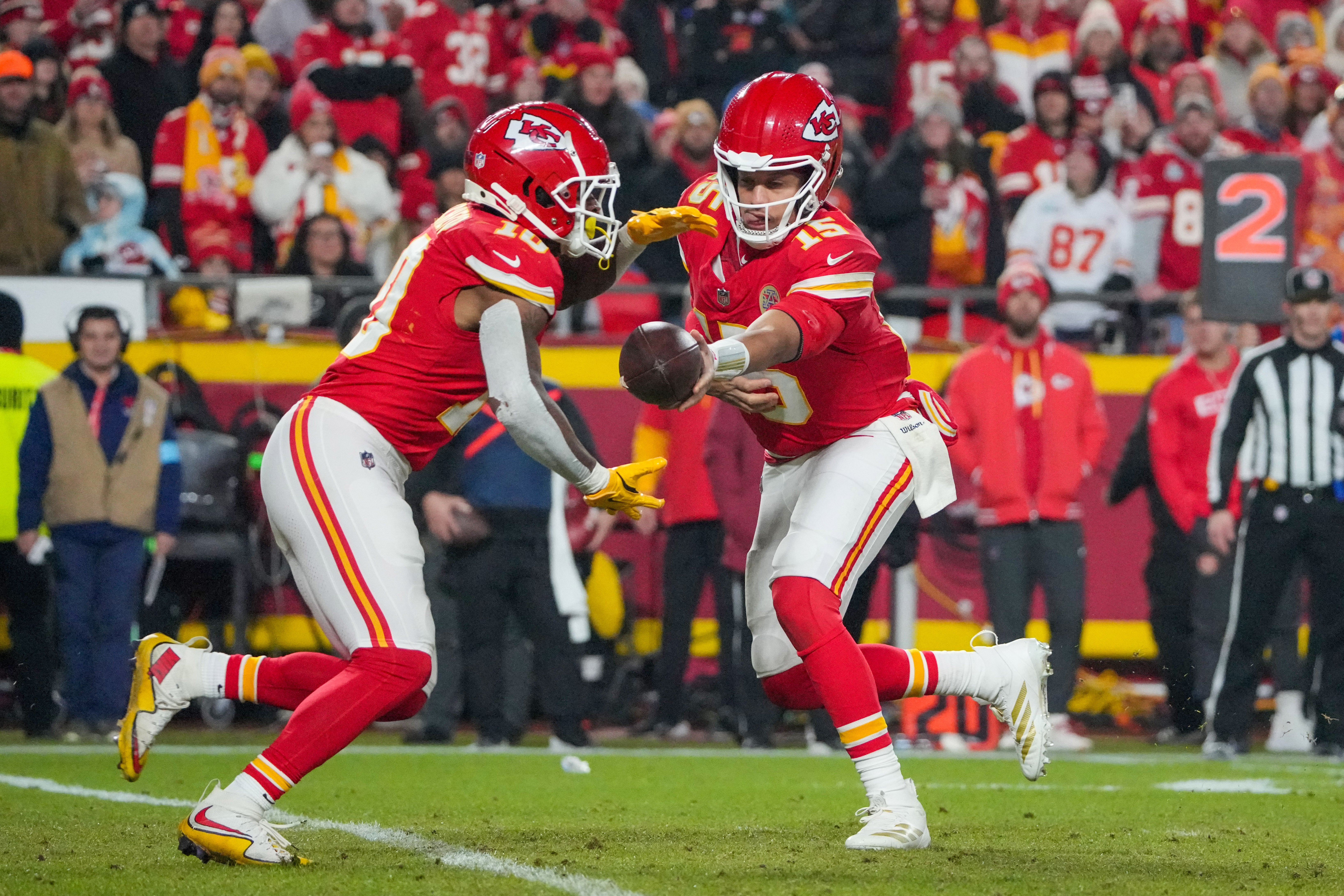 Dec 8, 2024; Kansas City, Missouri, USA; Kansas City Chiefs quarterback Patrick Mahomes (15) hands off to running back Isiah Pacheco (10) against the Los Angeles Chargers during the second half at GEHA Field at Arrowhead Stadium.
