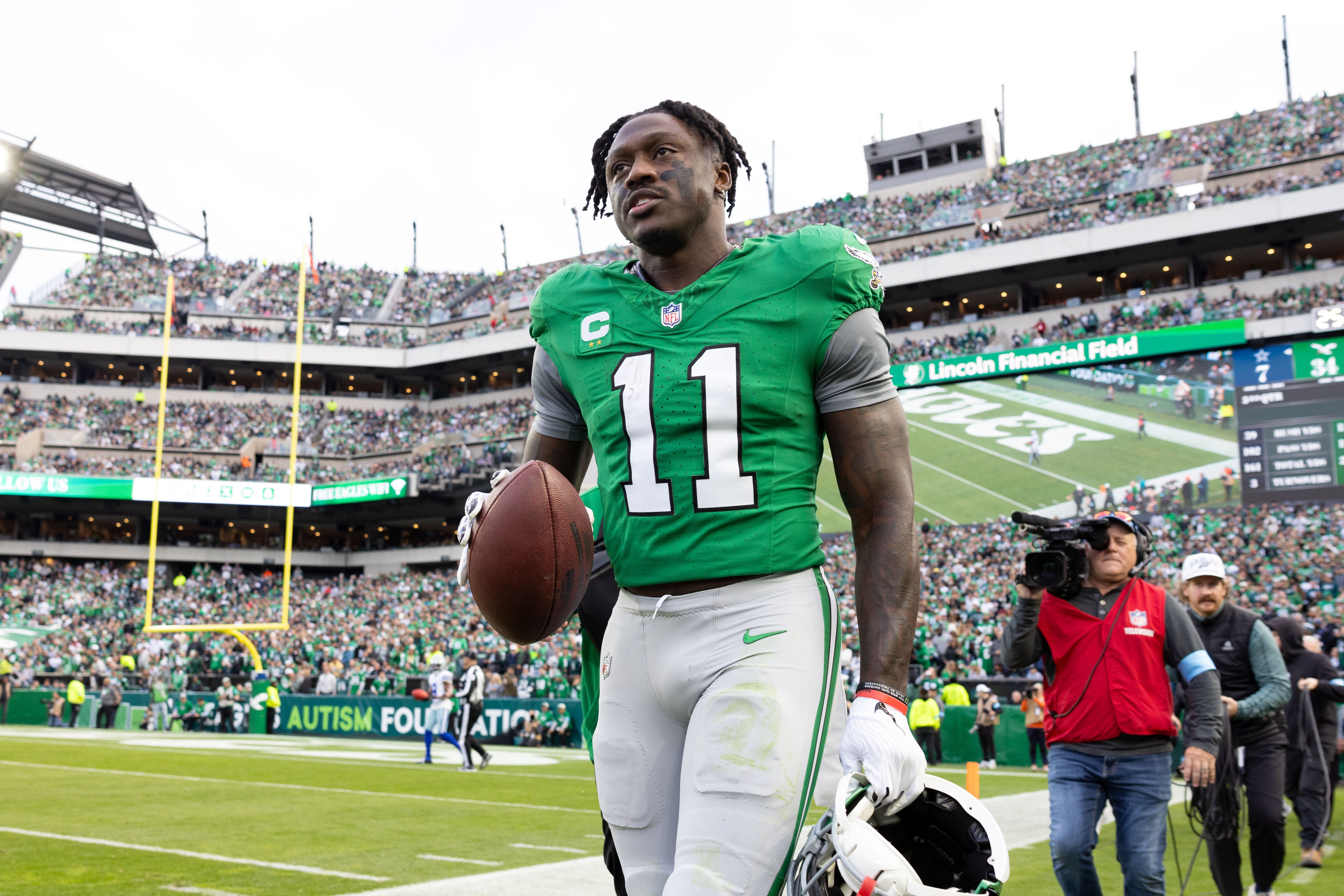 Philadelphia Eagles wide receiver A.J. Brown (11) carries his touchdown ball back to quarterback Tanner McKee (not pictured) during the third quarter against the Dallas Cowboys at Lincoln Financial Field
