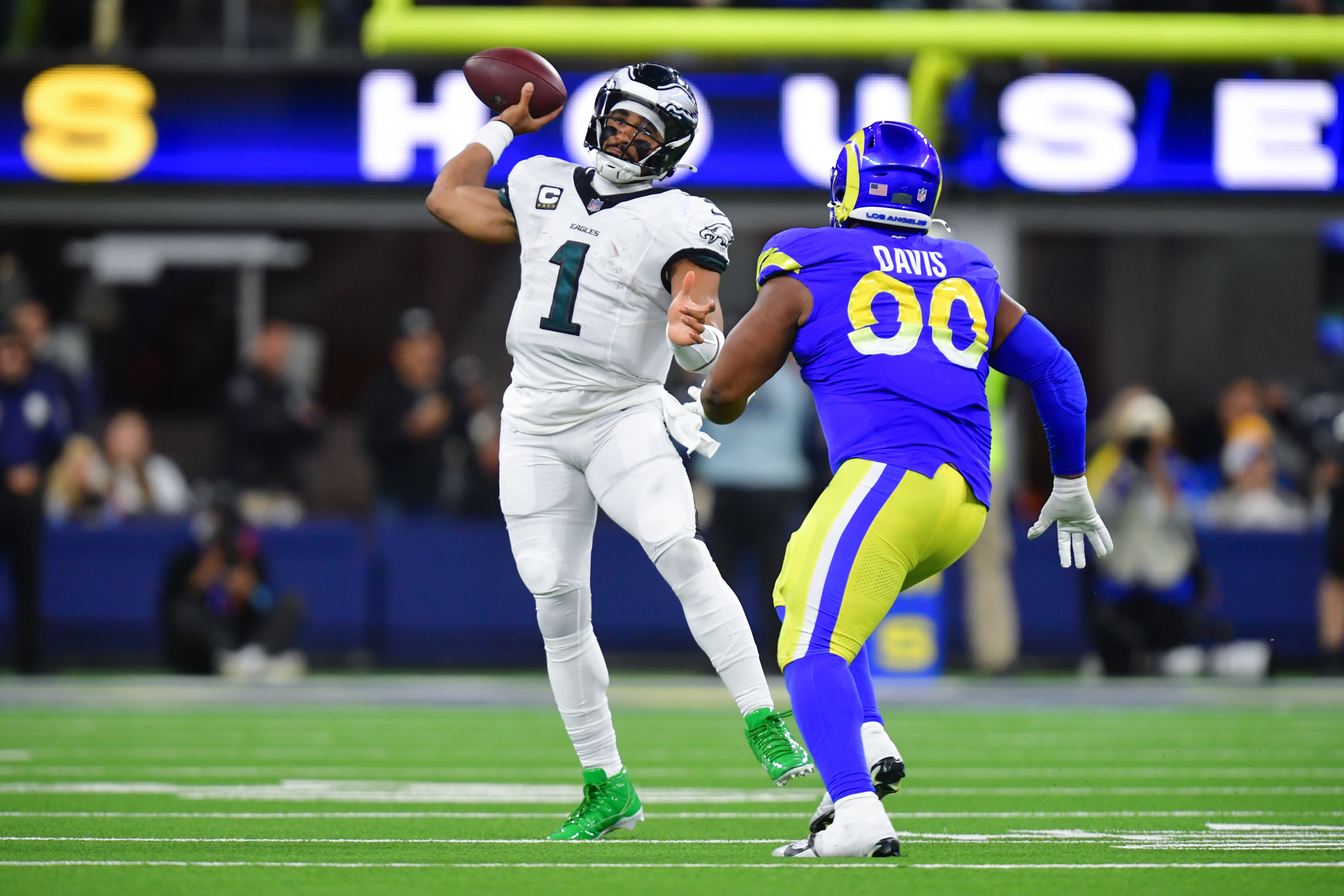 Philadelphia Eagles quarterback Jalen Hurts (1) throws as Los Angeles Rams defensive tackle Tyler Davis (90) moves in during the second half at SoFi Stadium.