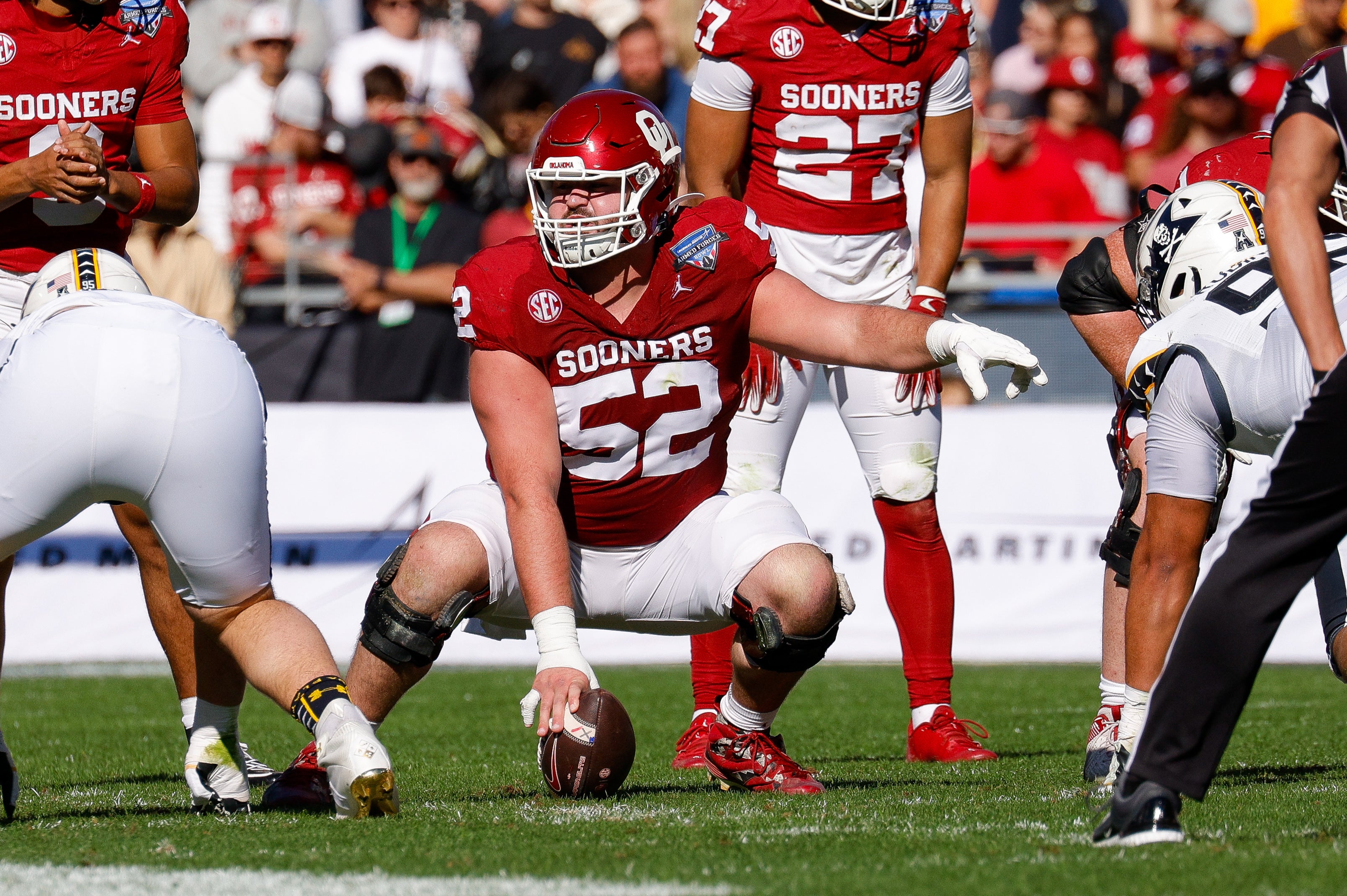 Dec 27, 2024; Fort Worth, TX, USA; Oklahoma Sooners offensive lineman Troy Everett (52) calls out signals during the first quarter against the Navy Midshipmen at Amon G. Carter Stadium.