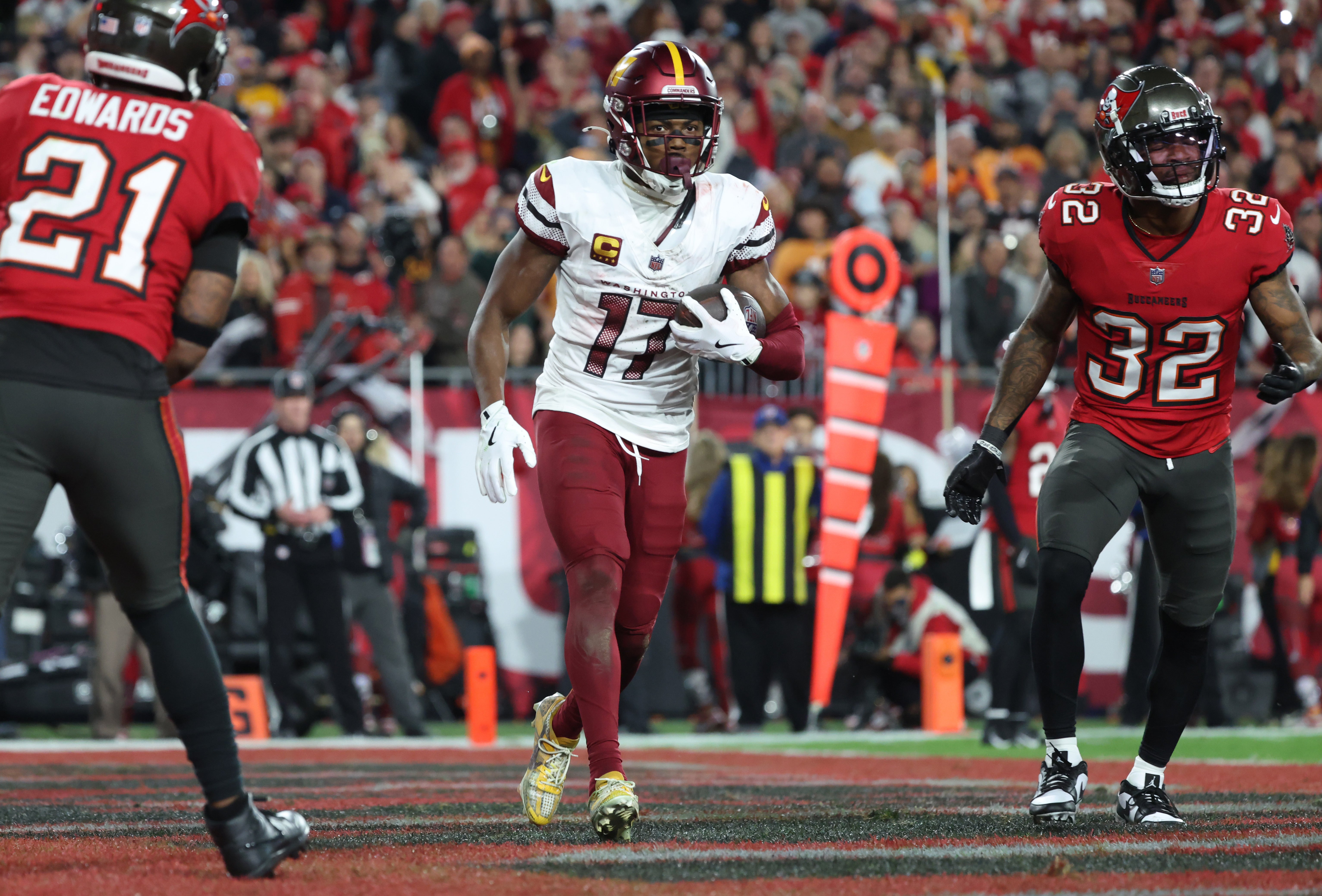 Jan 12, 2025; Tampa, Florida, USA; Washington Commanders wide receiver Terry McLaurin (17) reacts after catching a touchdown against Tampa Bay Buccaneers safety Josh Hayes (32) during the fourth quarter of a NFC wild card playoff at Raymond James Stadium.