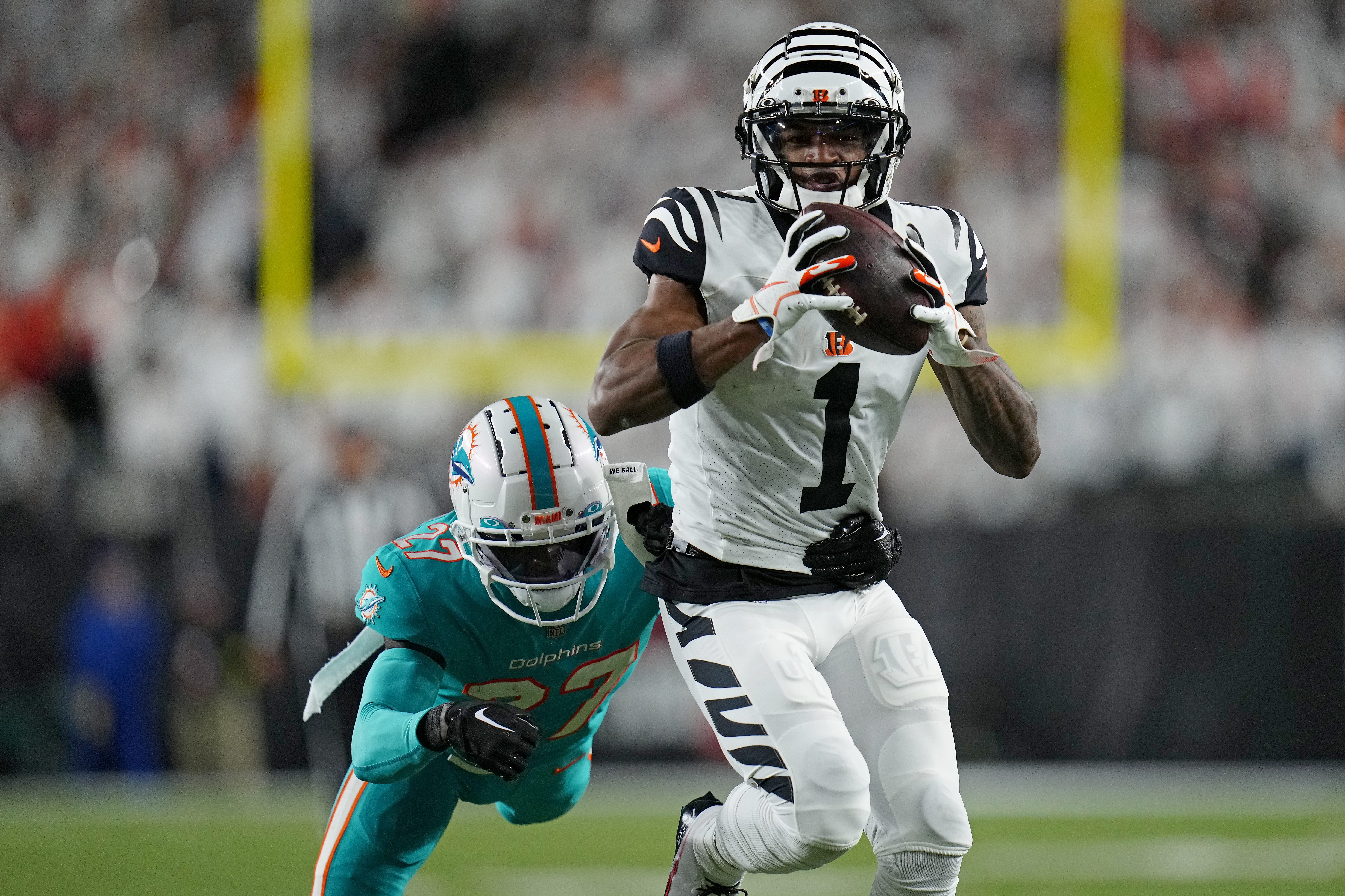 Cincinnati Bengals wide receiver Ja'Marr Chase (1) catches a deep pass over Miami Dolphins cornerback Keion Crossen (27) in the fourth quarter of the NFL Week 4 game between the Cincinnati Bengals and the Miami Dolphins at PayCor Stadium in downtown on Thursday, Sept. 29, 2022. The Bengals improved to 2-2 with a 27-15 win over the Dolphins.